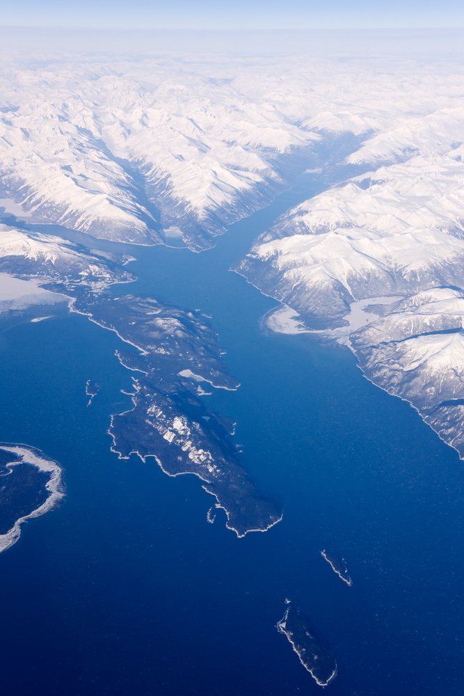 Aerial view of snow-covered mountains and fjords