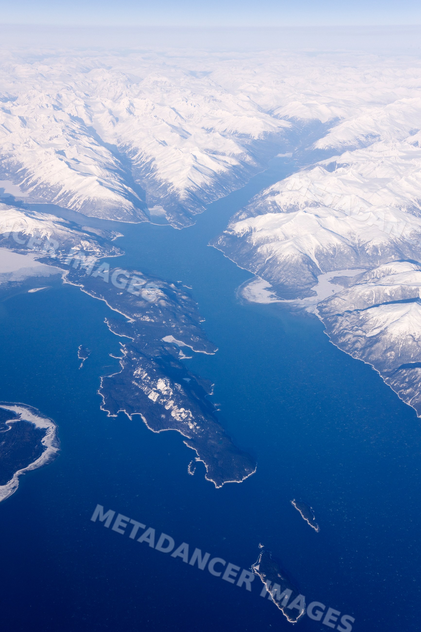 Aerial view of snow-covered mountains and fjords