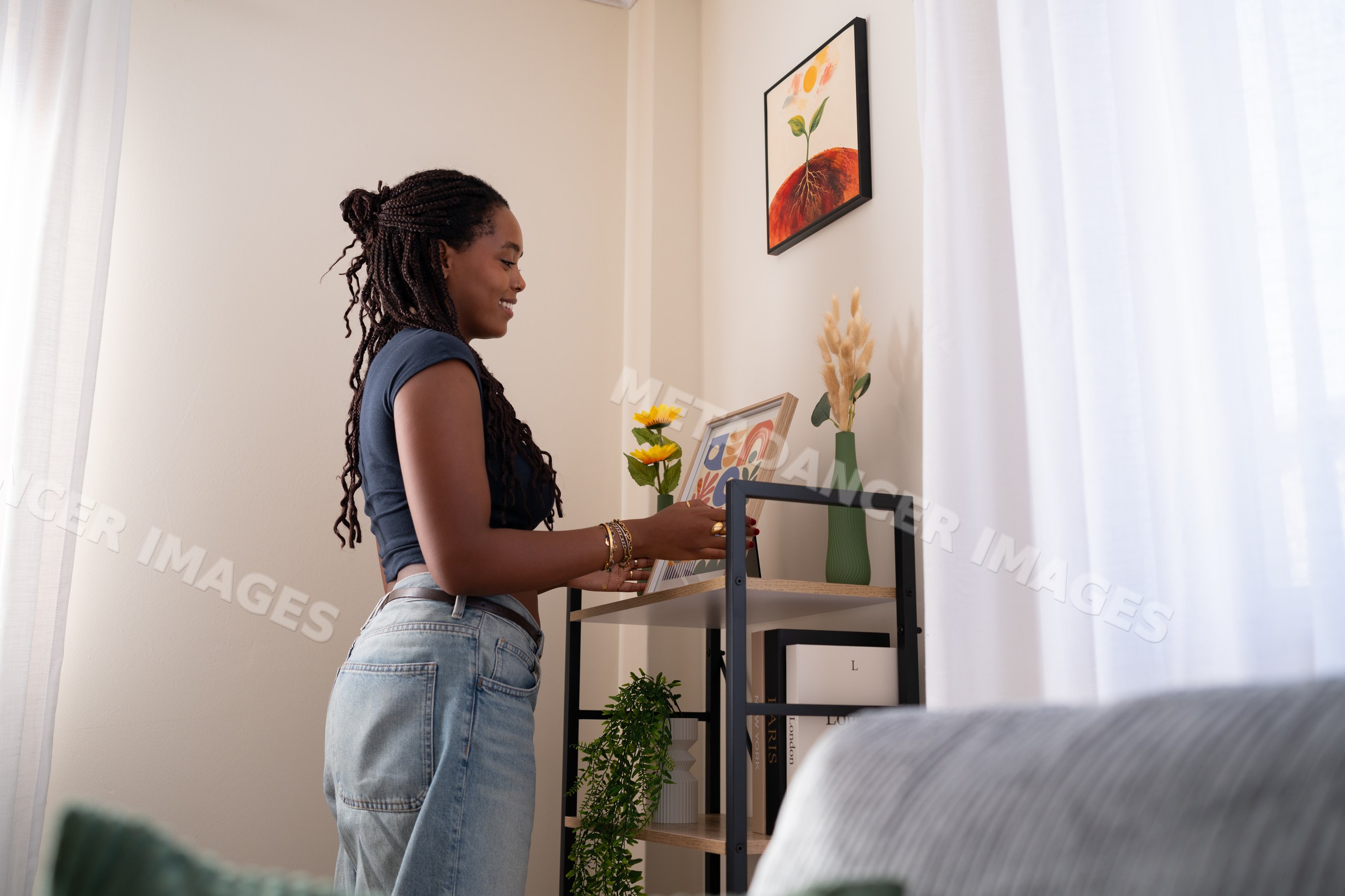 African American woman decorates a shelf