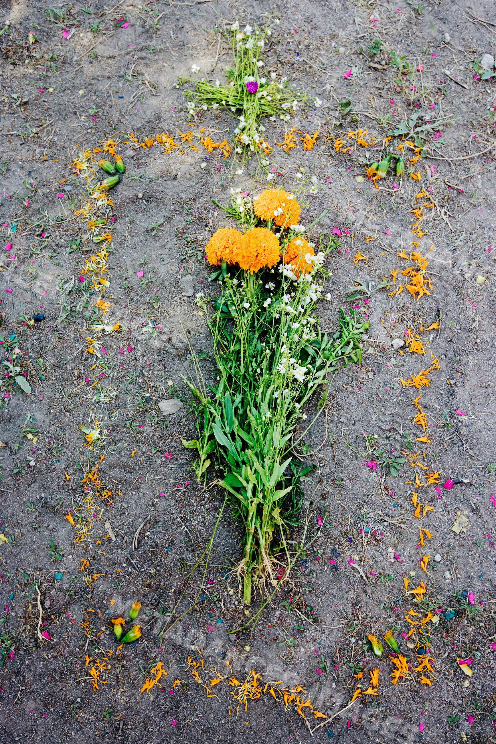 Floral arrangement on grave site with cross decoration mexico