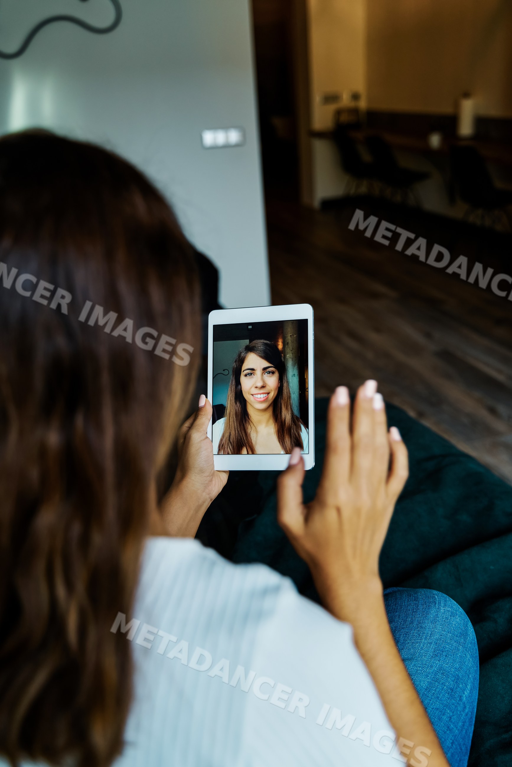A woman using a tablet for a video call