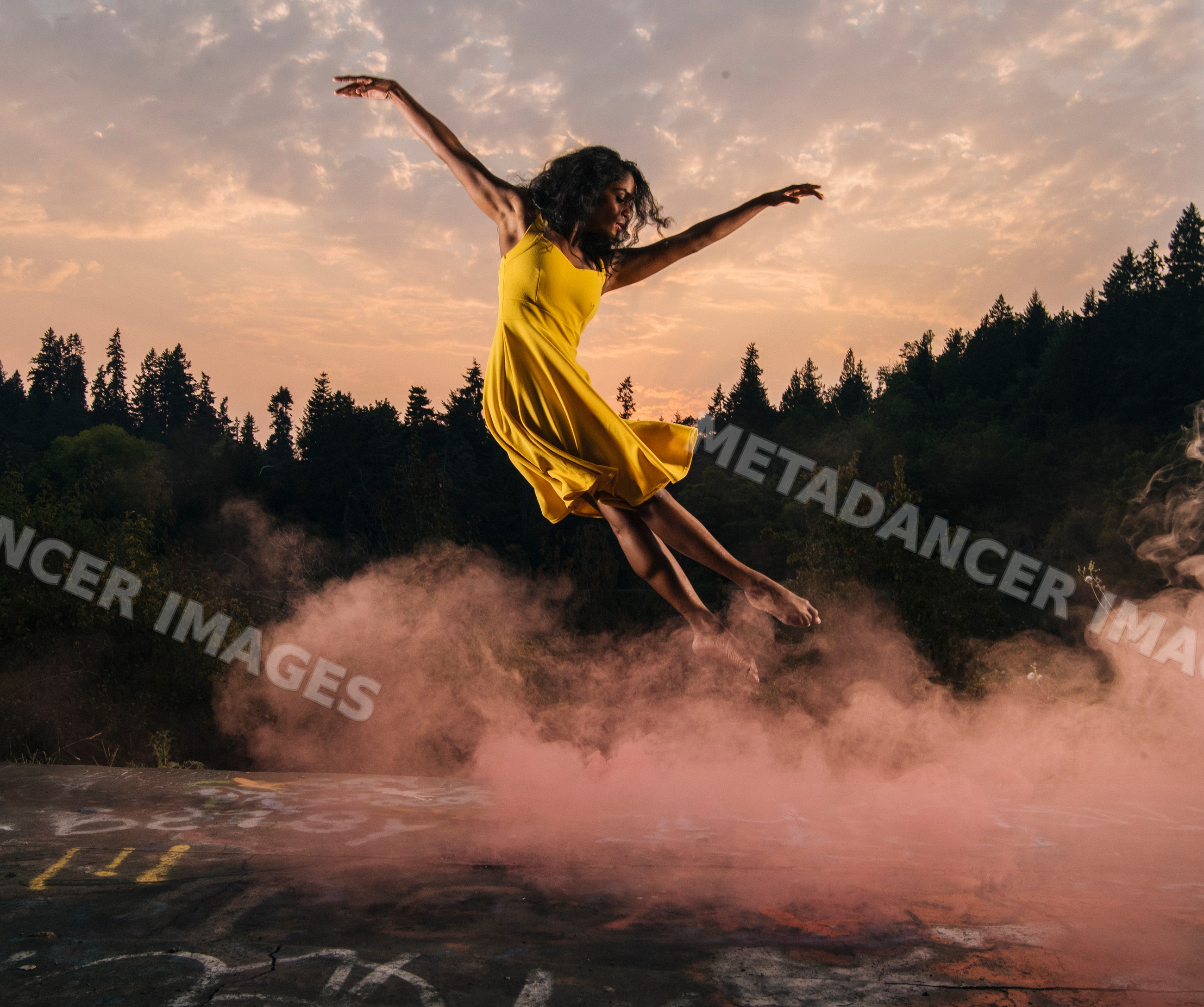 South Asian woman jumping outdoors