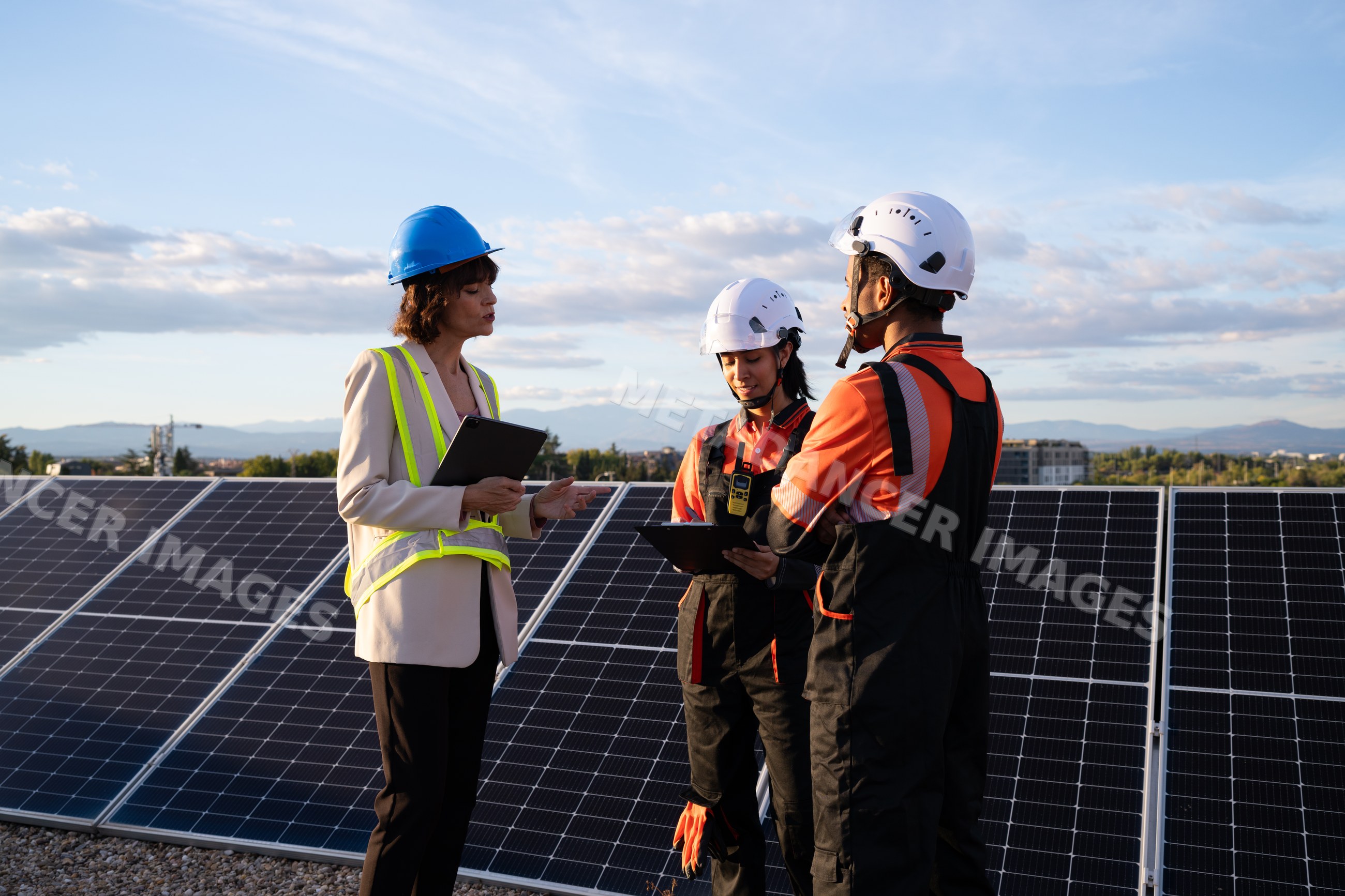 Engineers inspecting solar panels on a solar farm