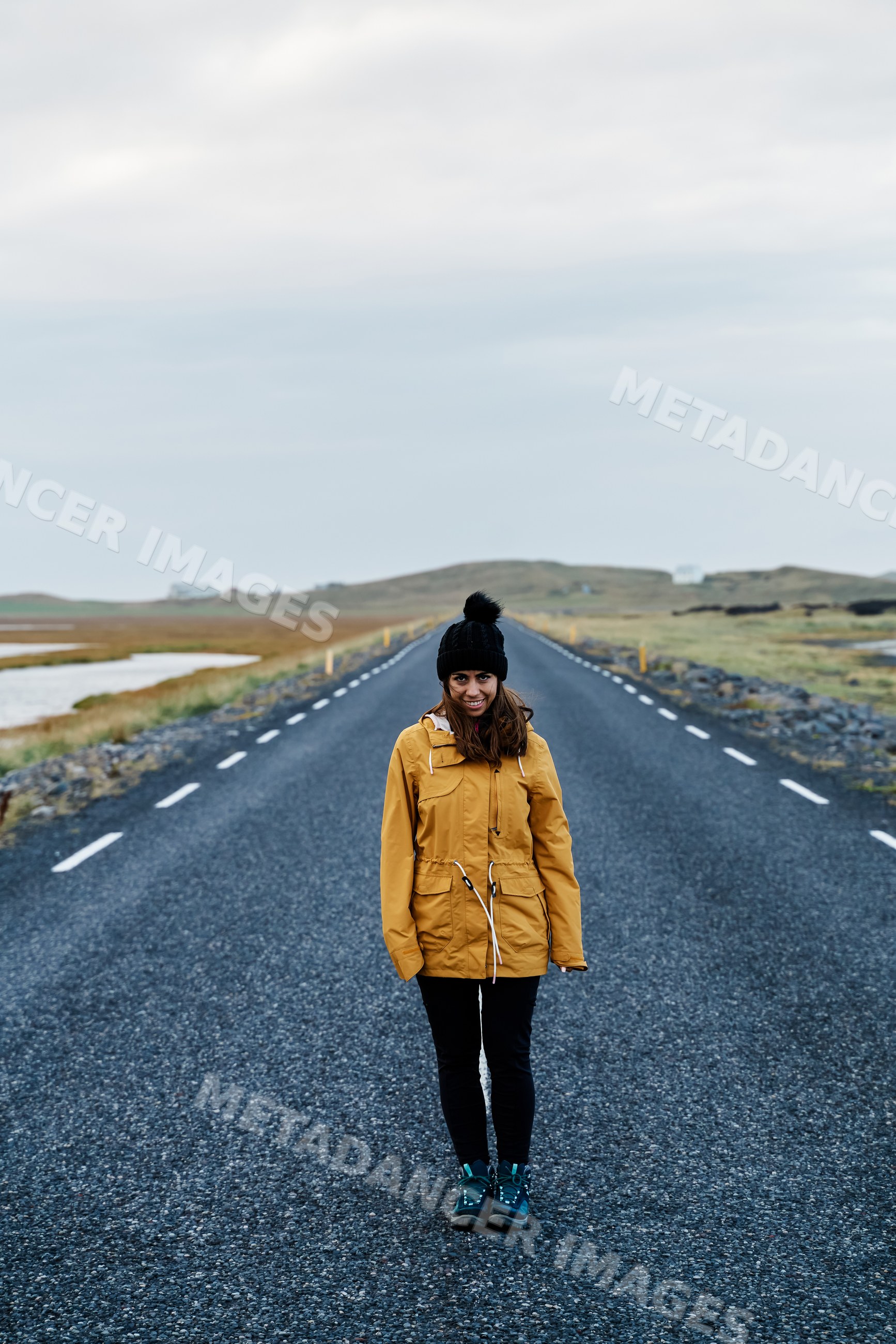 A white woman stands on a rural road