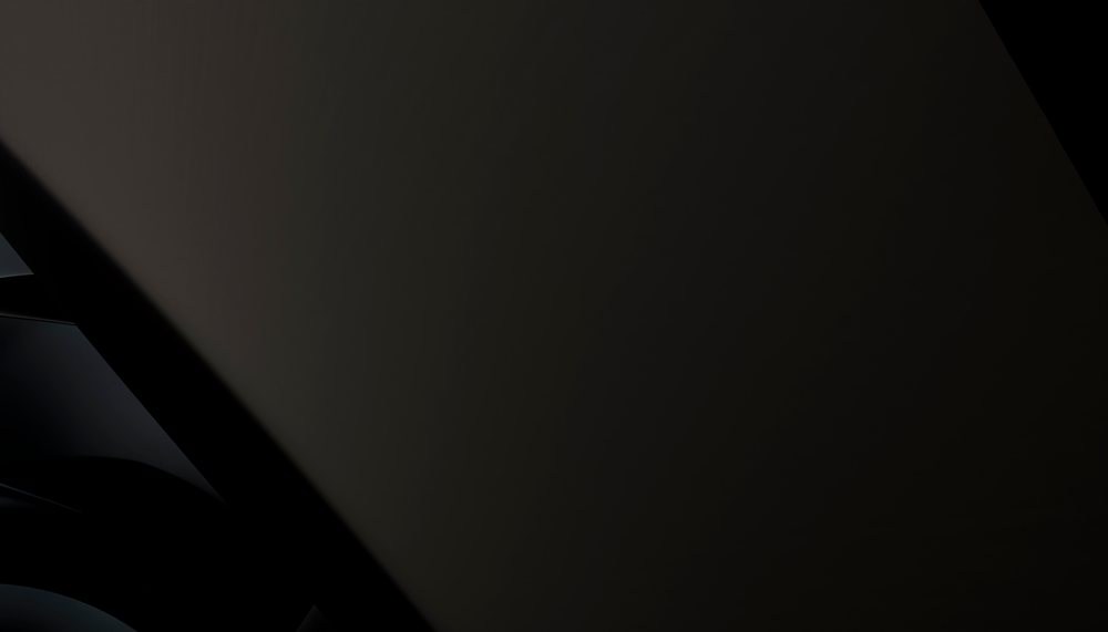 Close-up of a smooth black surface with abstract reflective shapes