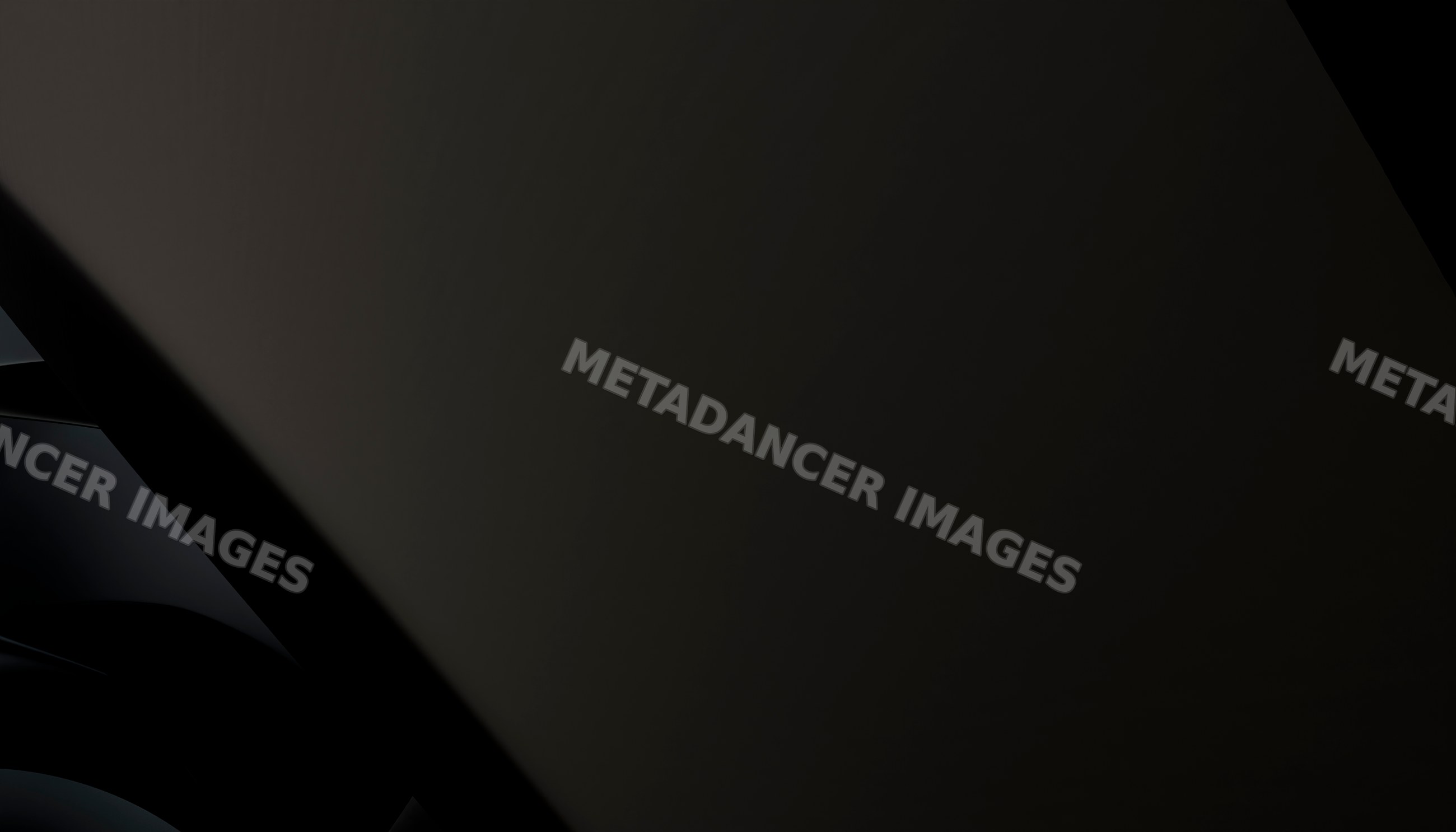 Close-up of a smooth black surface with abstract reflective shapes
