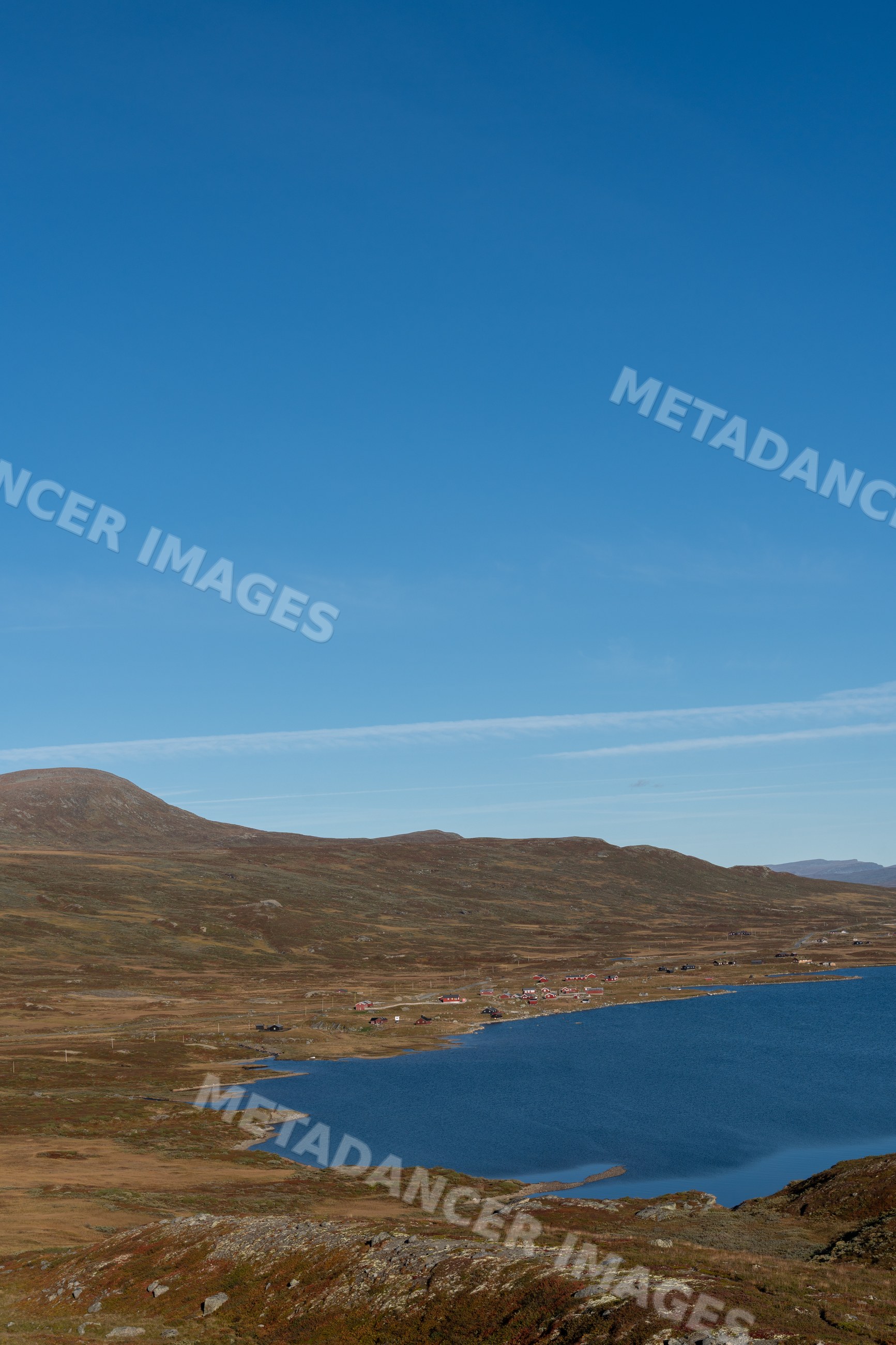 Scenic lake and hills landscape under clear sky