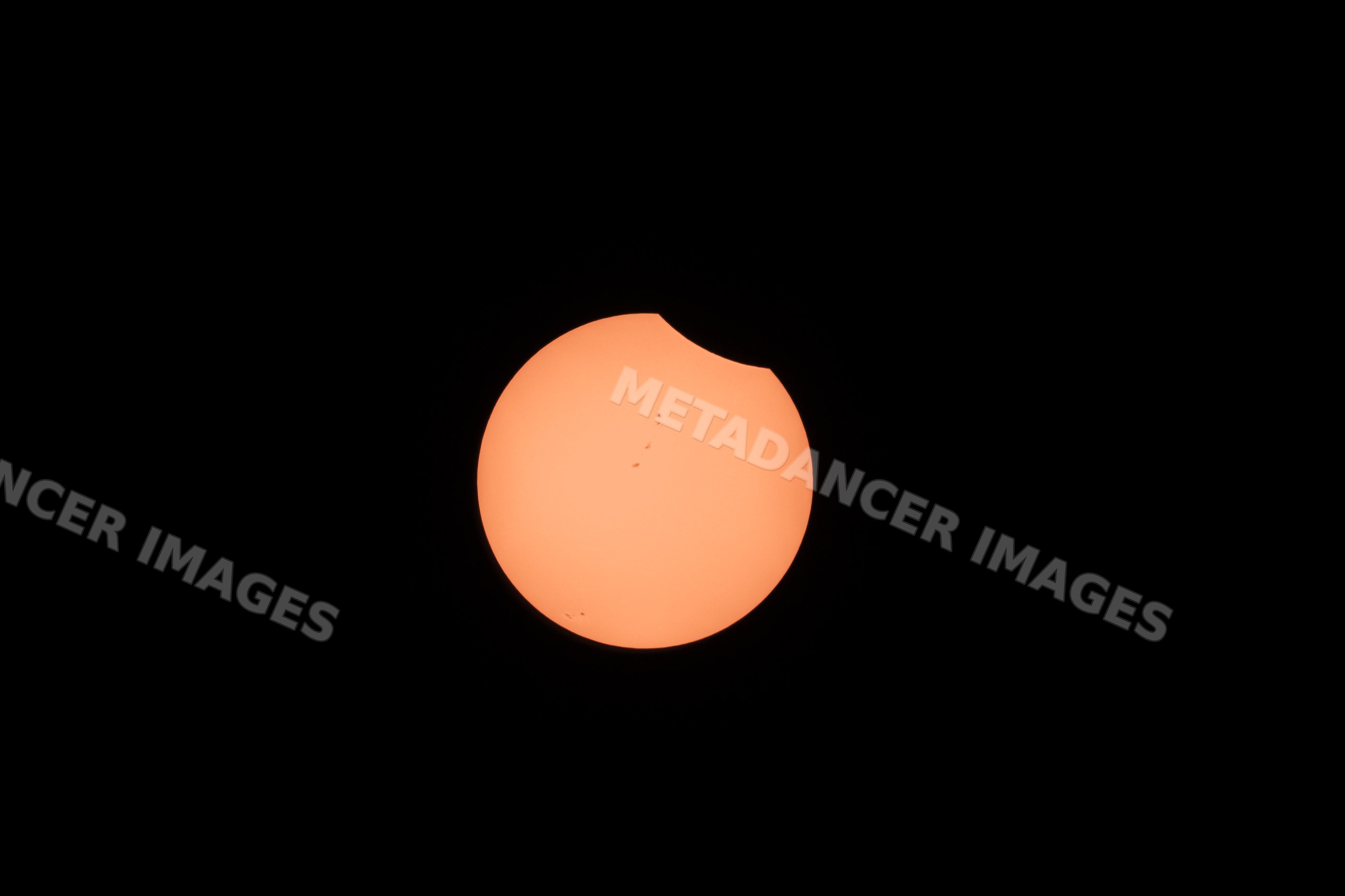 Partial solar eclipse seen from Los Angeles with visible sunspots