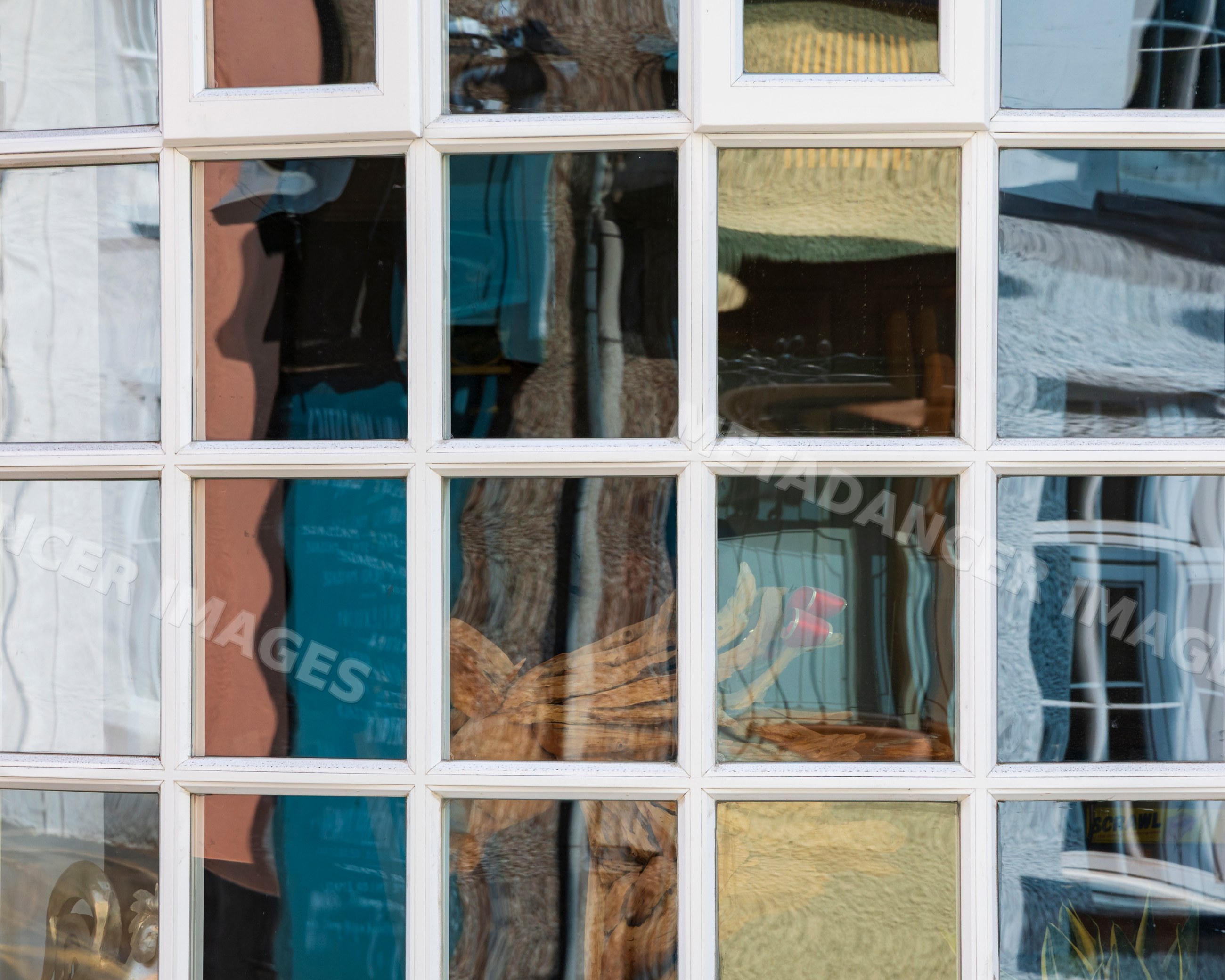 House window with distorted reflections in crickhowell, Wales