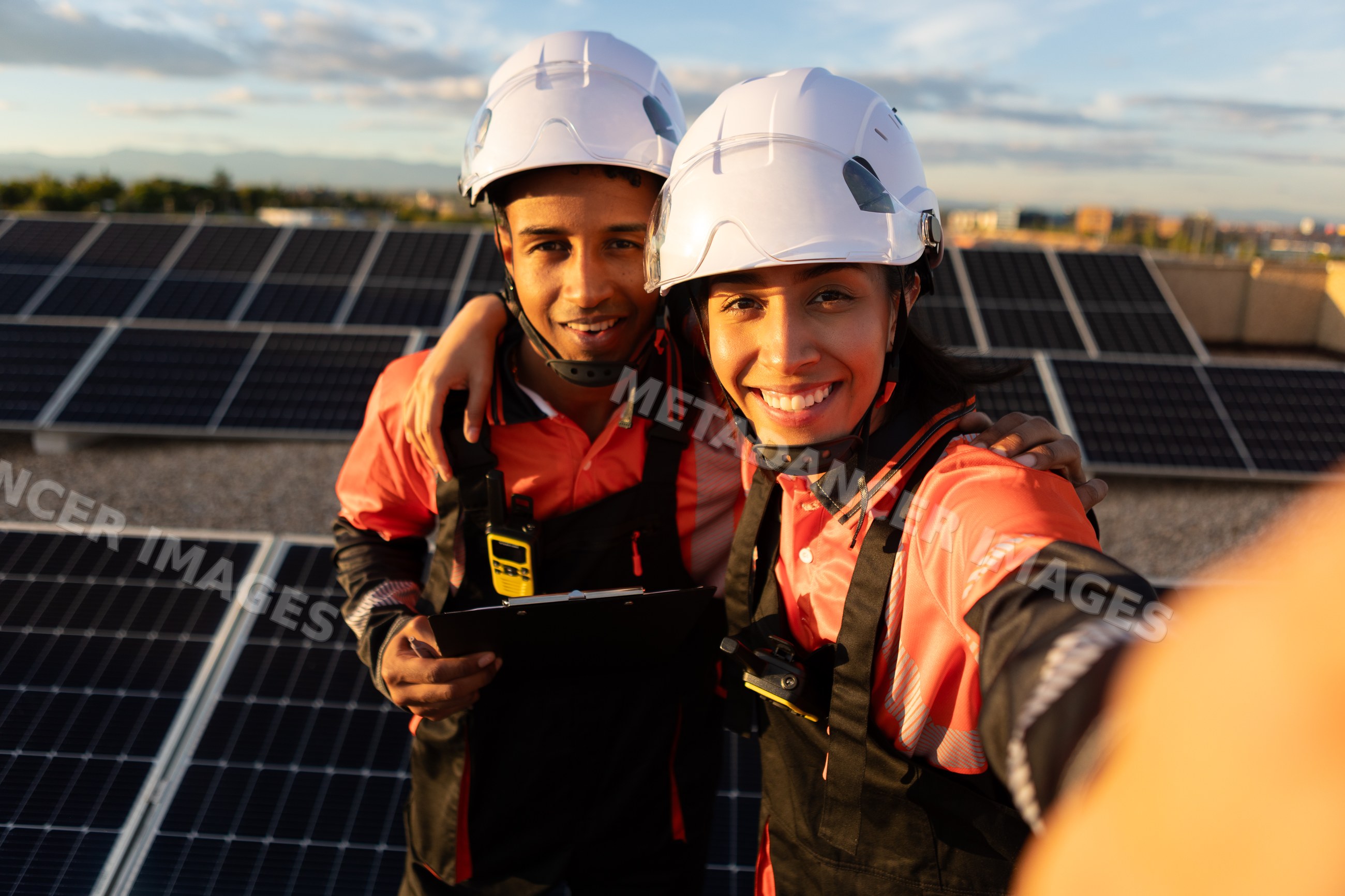 Technicians taking selfie on rooftop solar panel installation