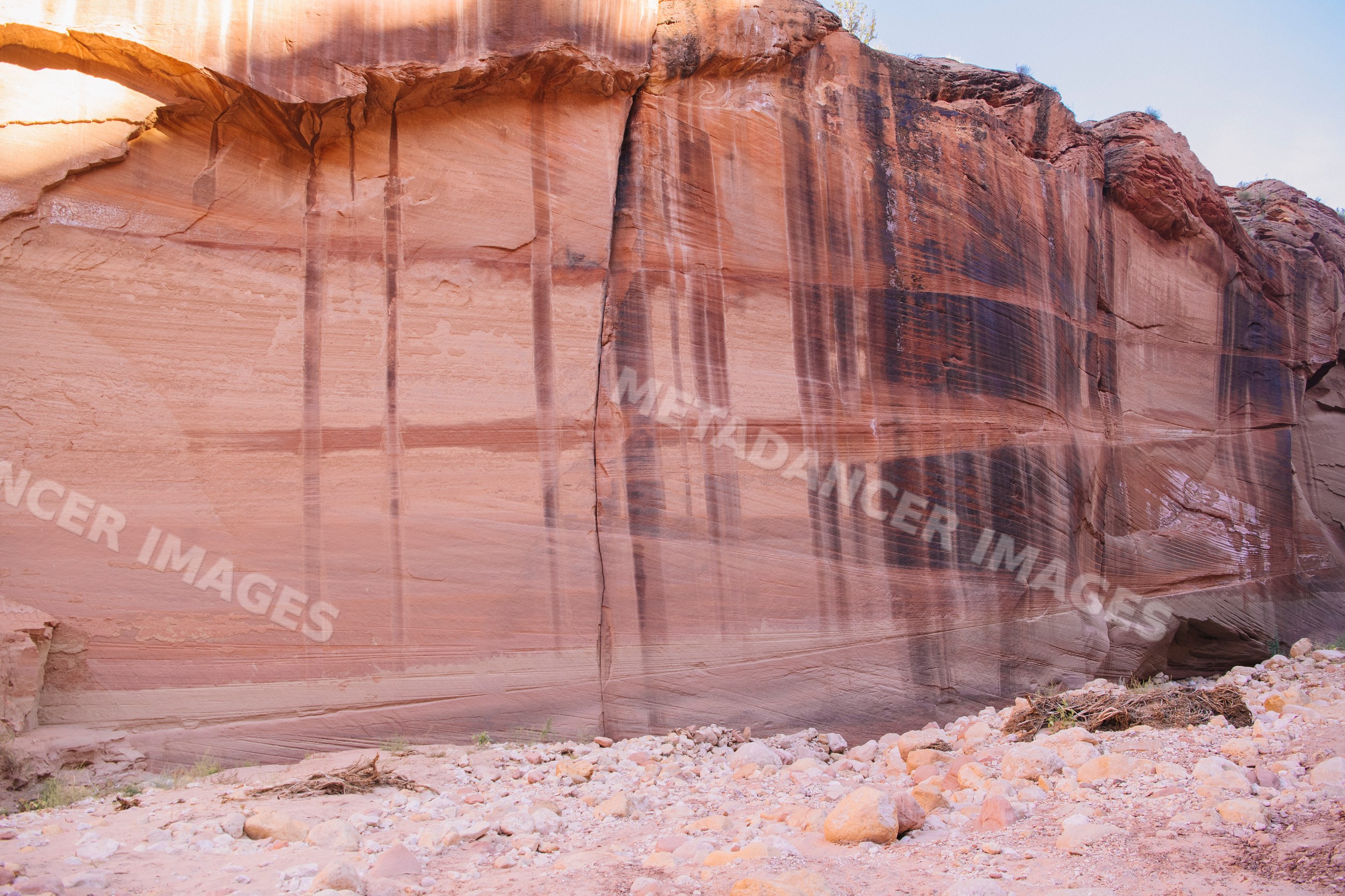 Rock wall with vertical streaks in slot canyon of Utah sandstone