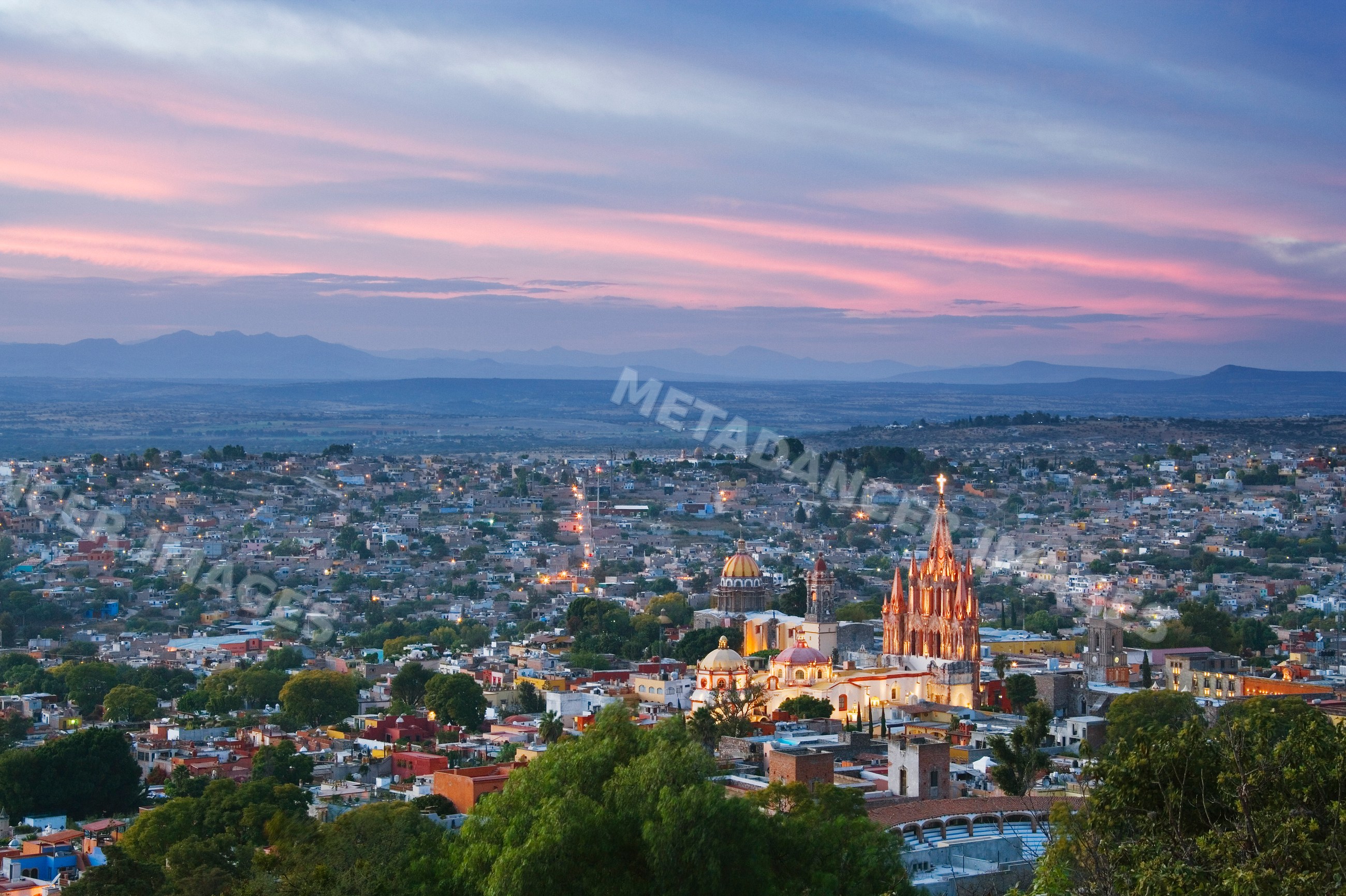 San miguel de allende cityscape with sunset and mountains