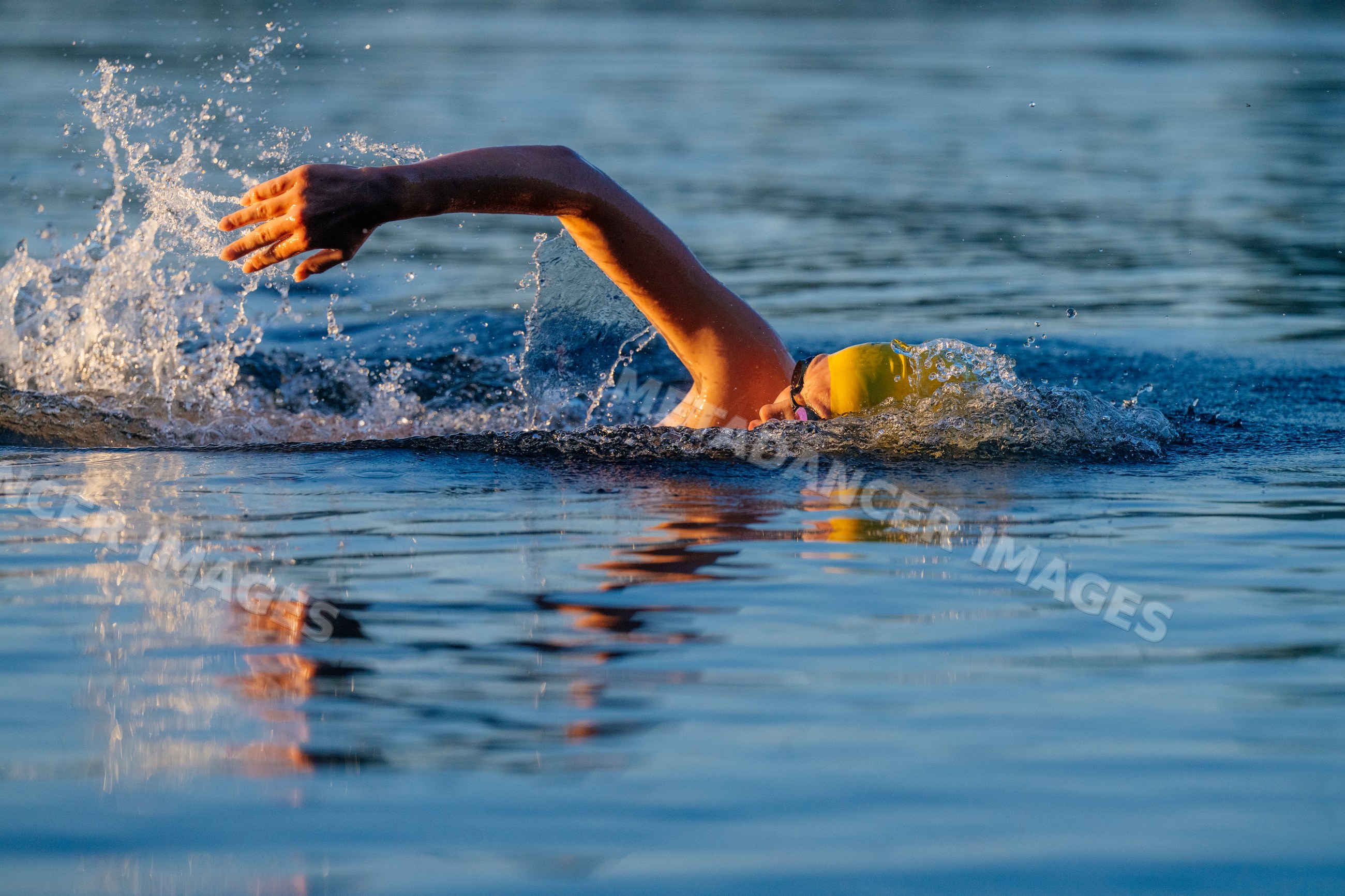 White swimmer performing freestyle stroke in open water