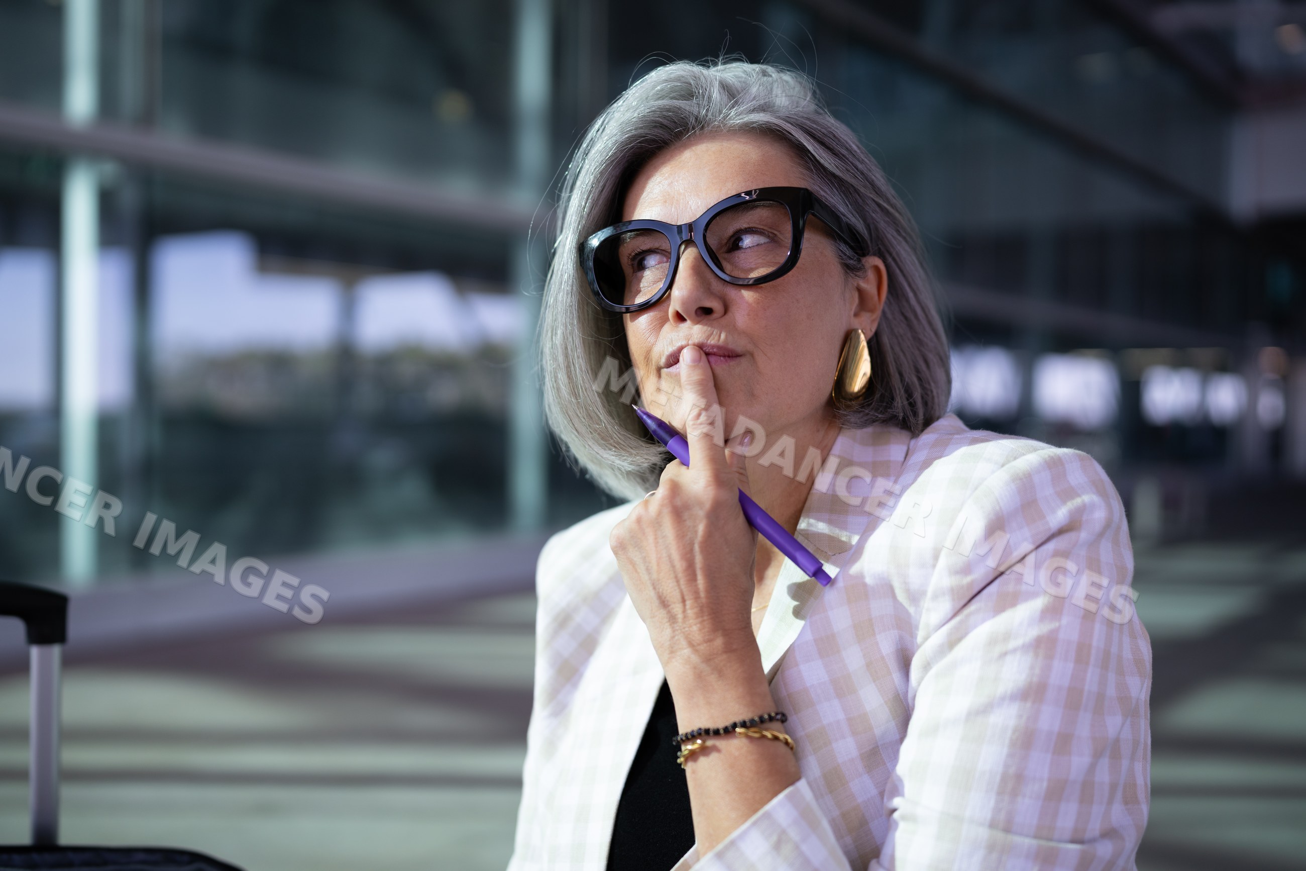 Businesswoman with gray hair thinking outdoors