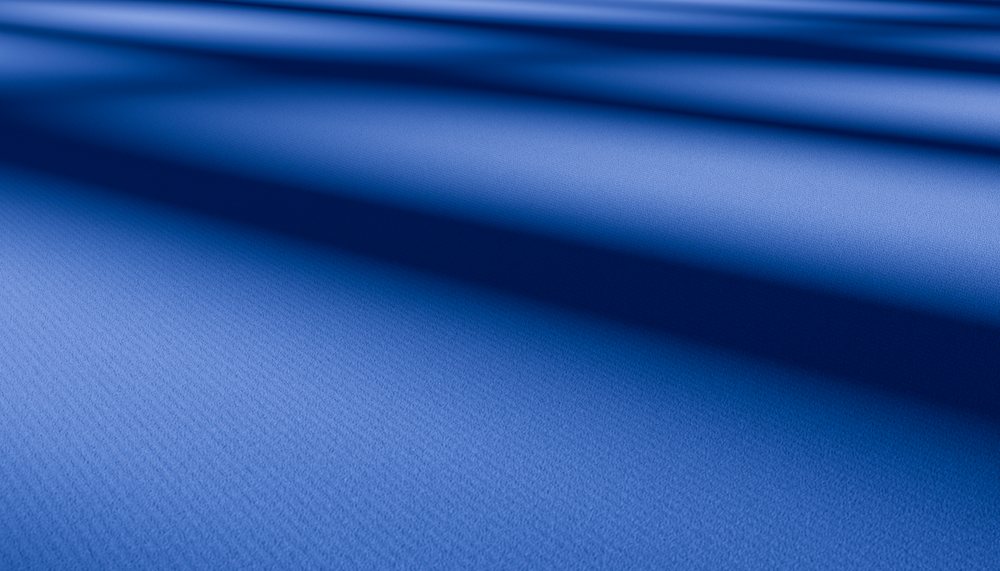 Closeup of soft blue fabric with folds and textured surface