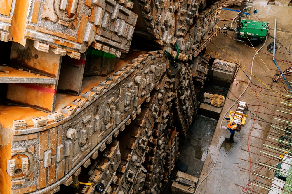 Engineers inspect tunnel boring machine during construction