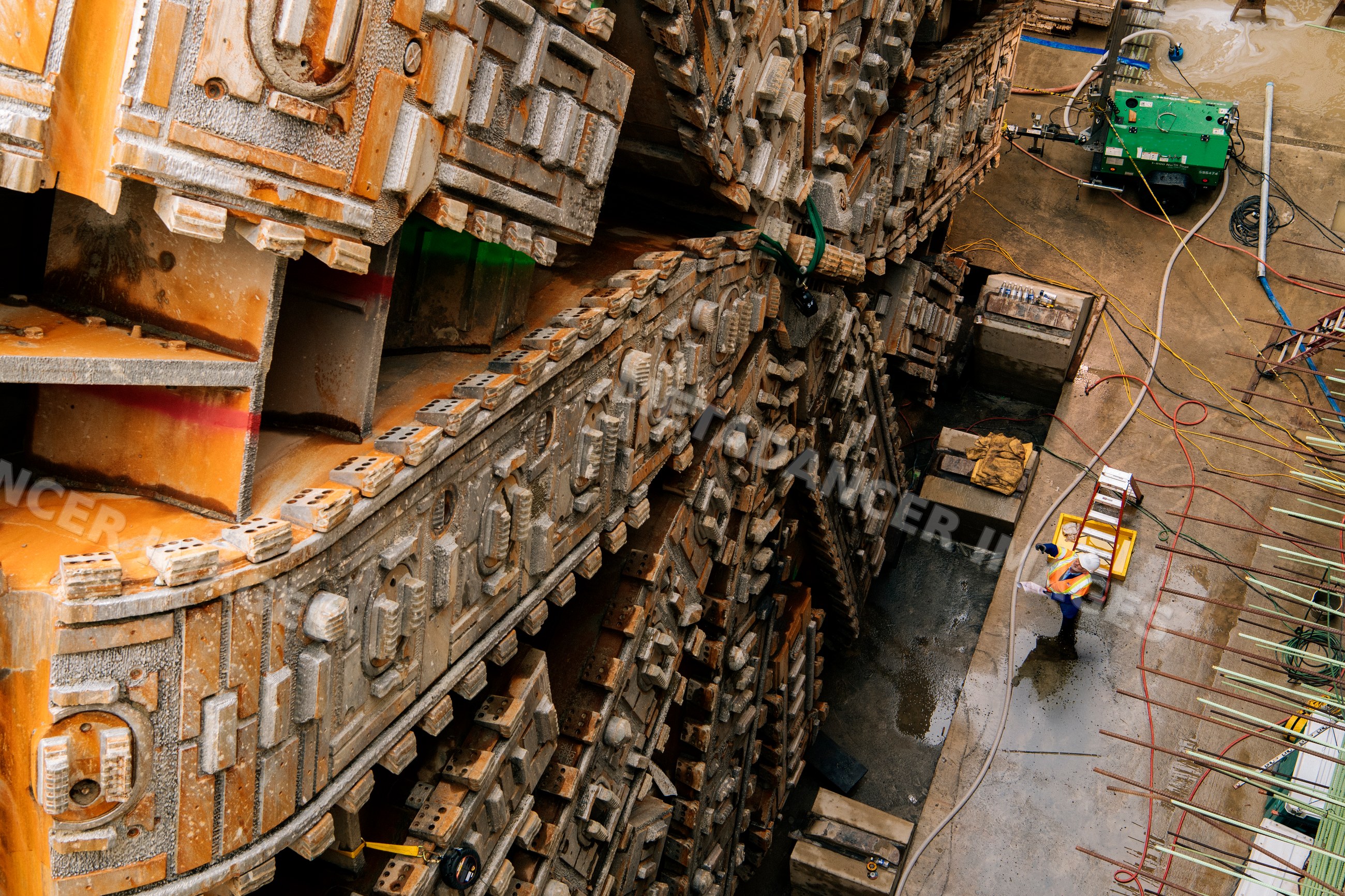 Engineers inspect tunnel boring machine during construction