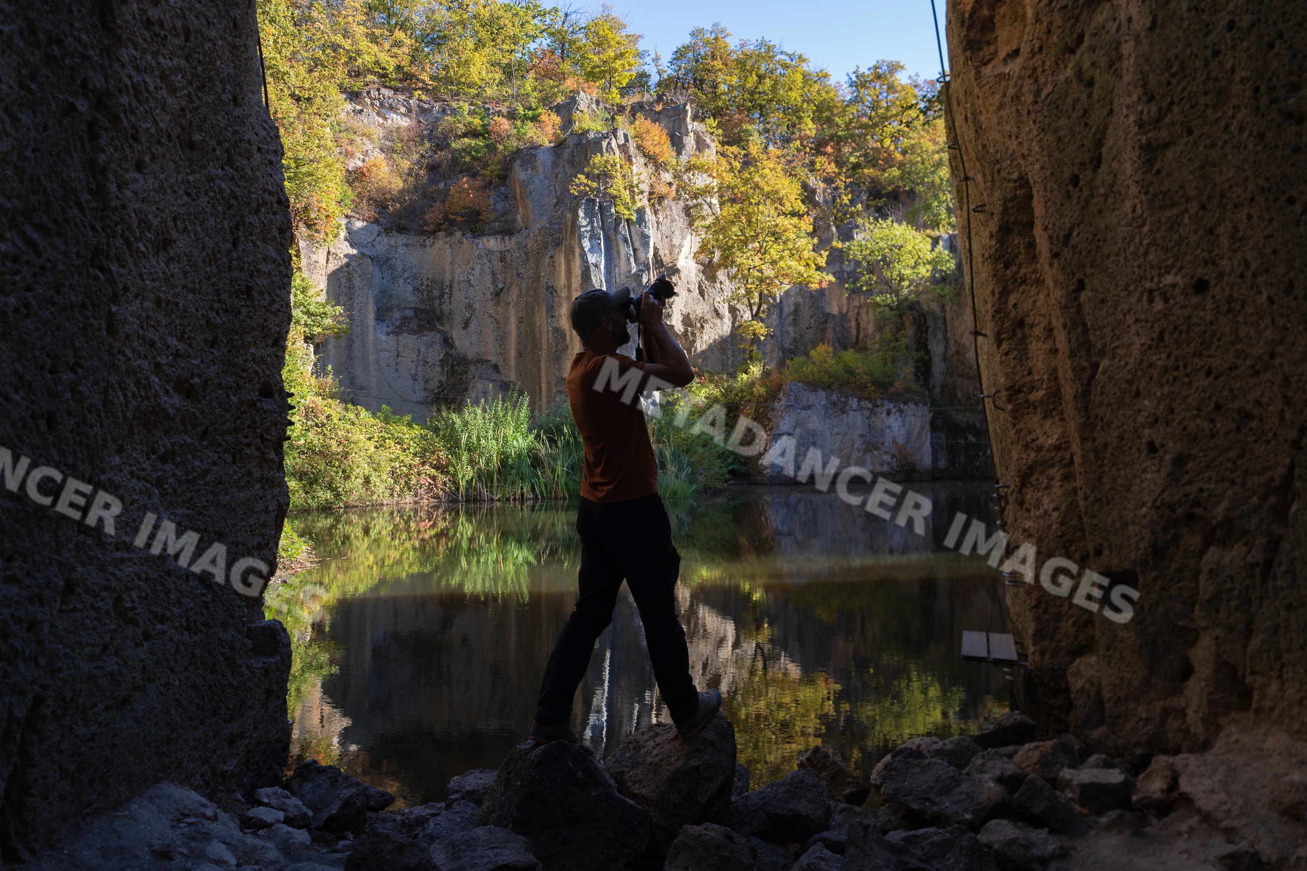 Photographer capturing images at a flooded millstone quarry