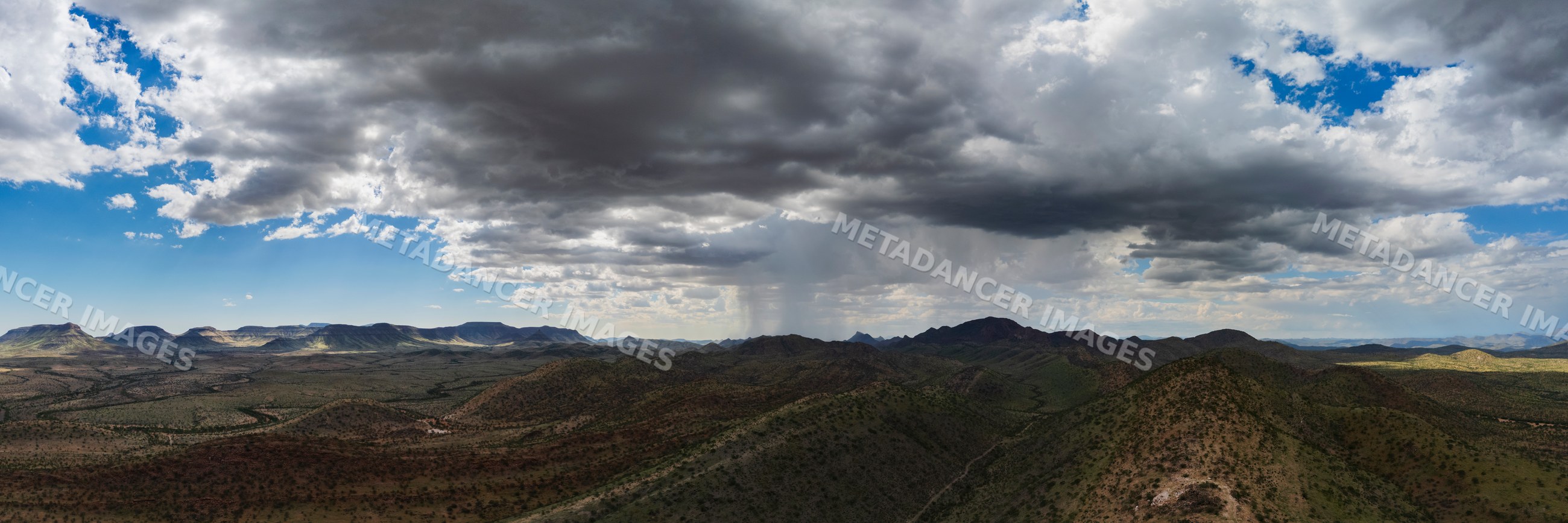 Storm clouds gathering over savanna landscape in etambura, Namibia