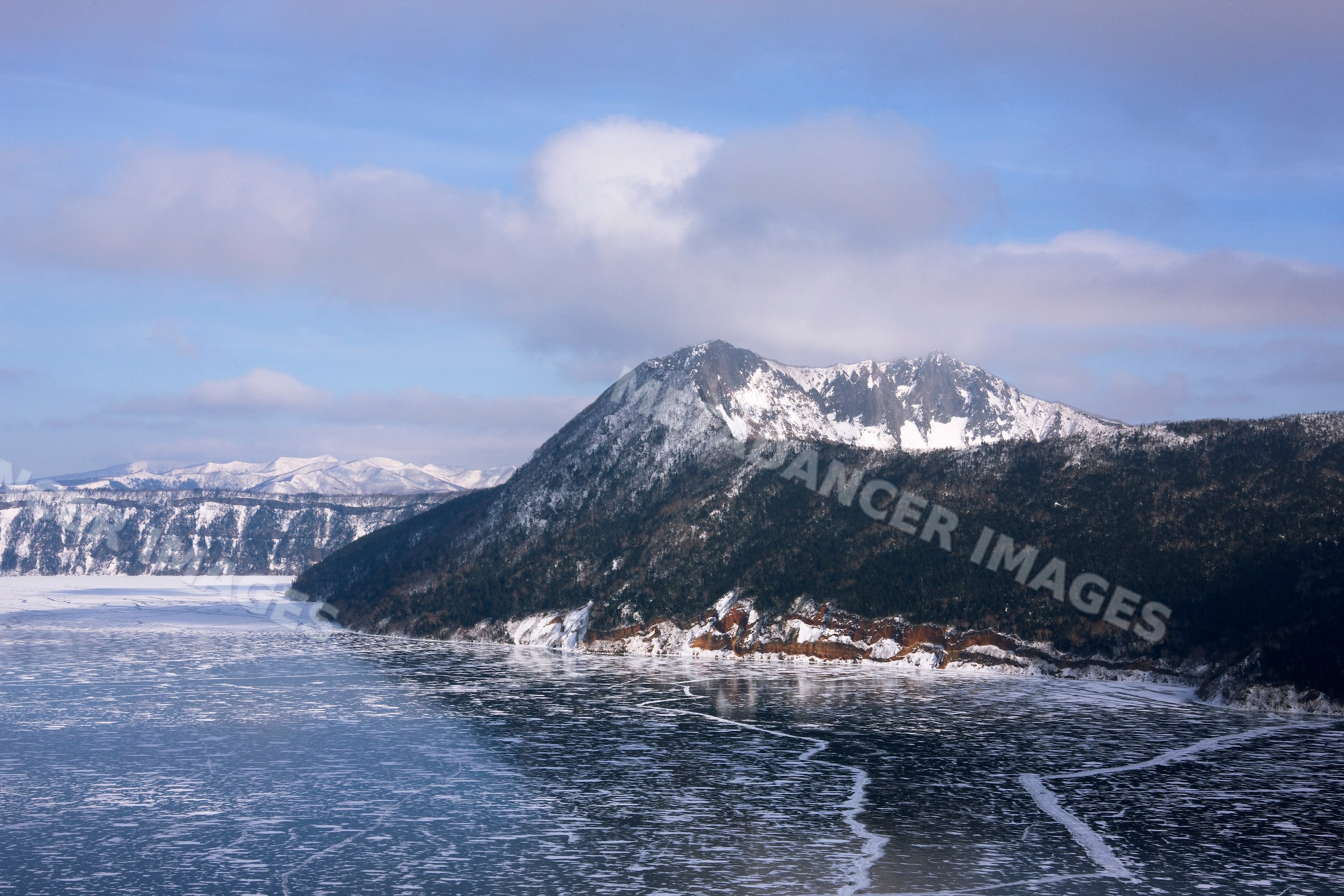 Frozen lake mashu and snow-covered mountain