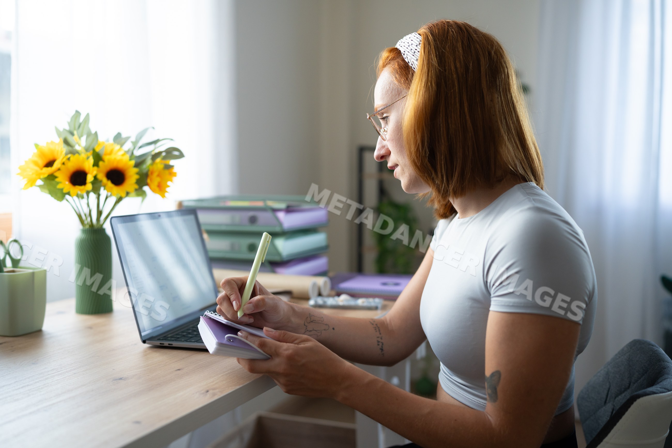 A white woman writing notes