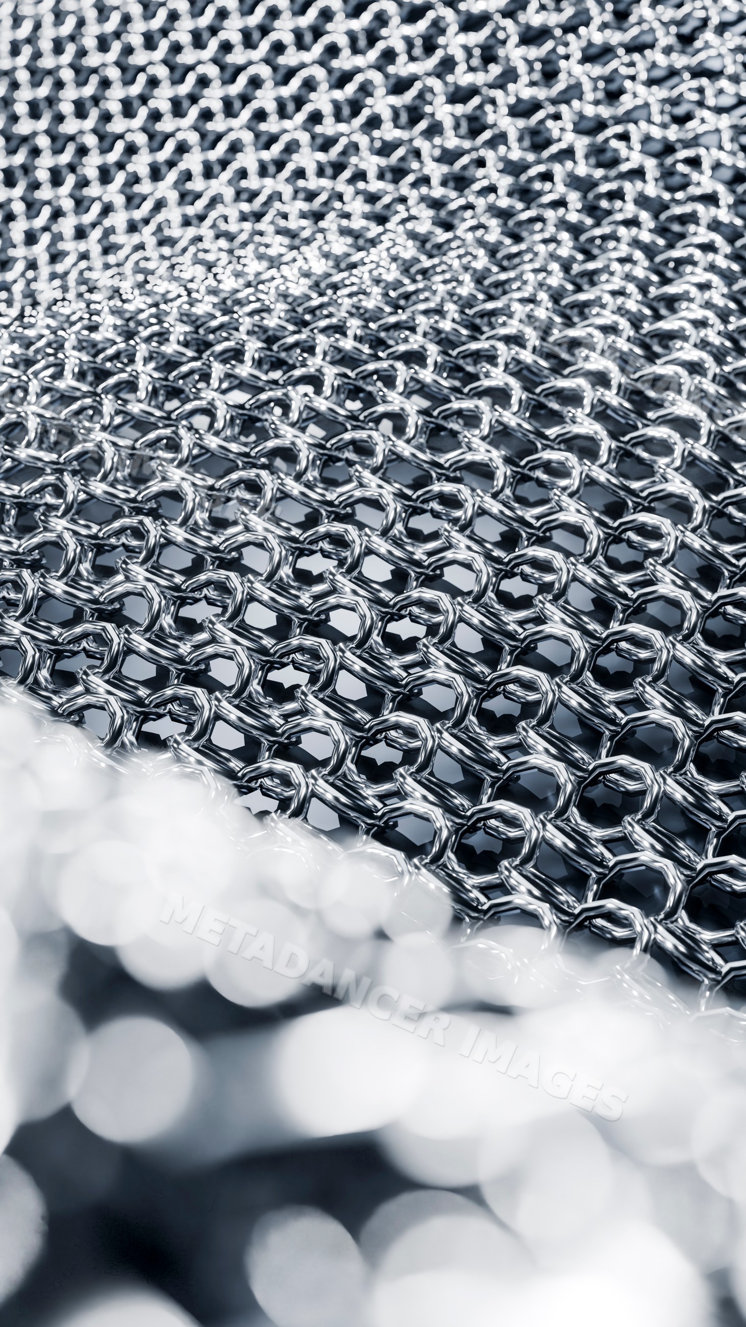 Close-up of interlocking shiny metal rings forming mesh pattern