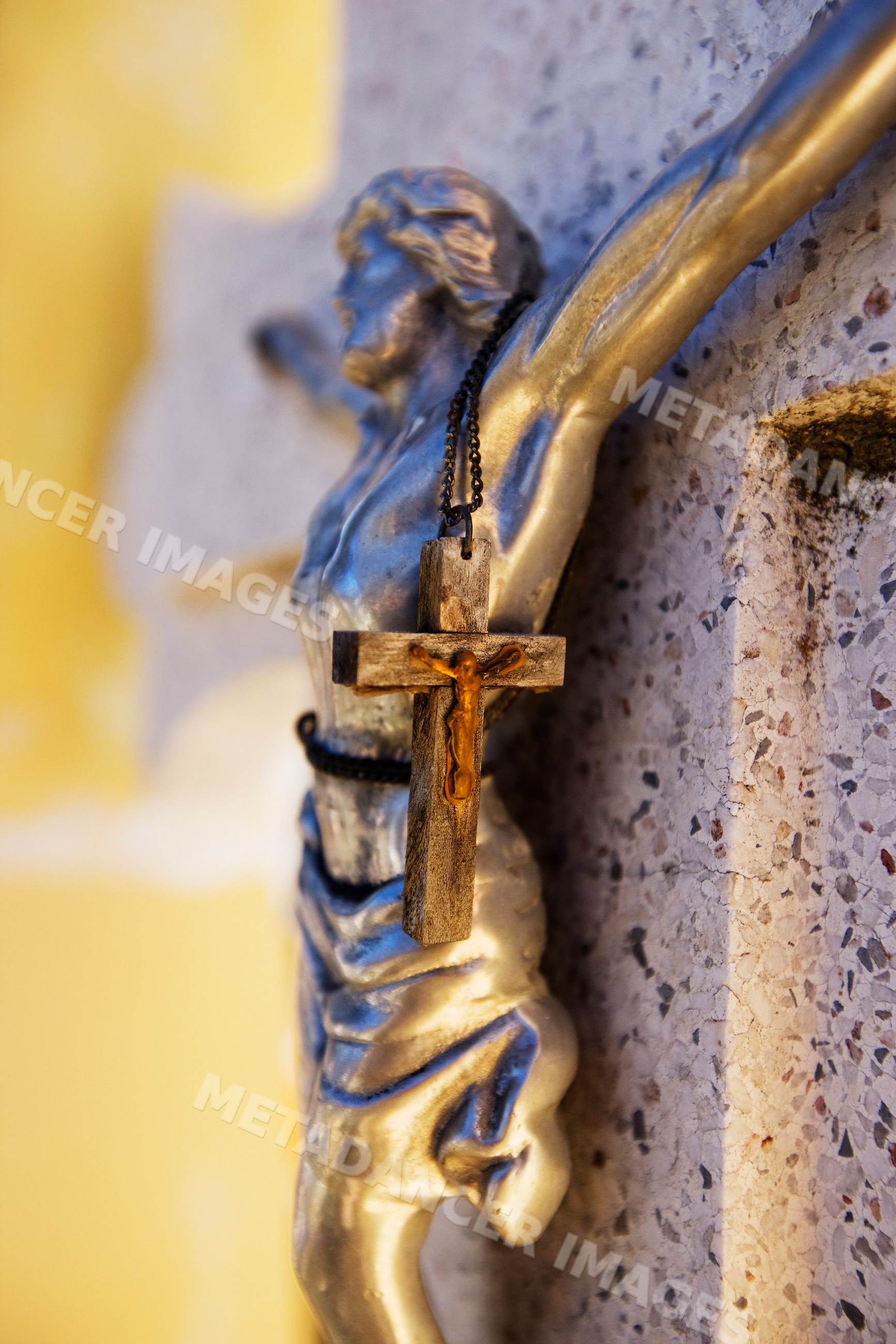Close-up of religious crucifix statue on stone headstone