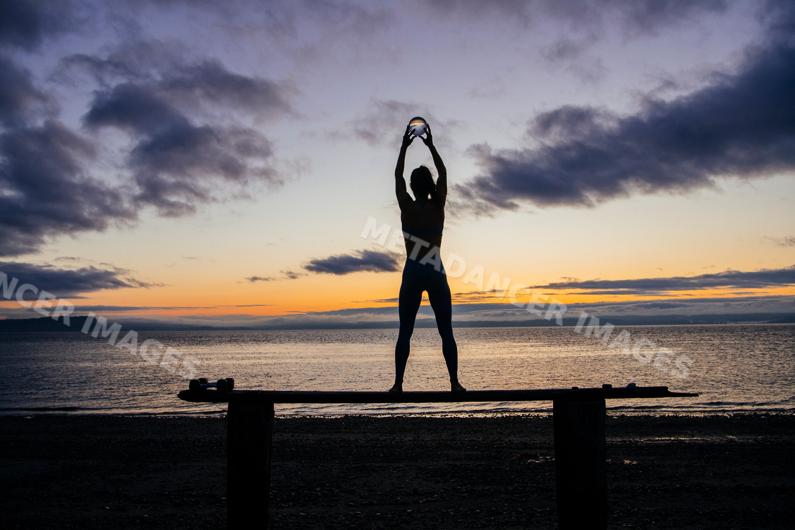 Silhouette of white woman holding glass ball