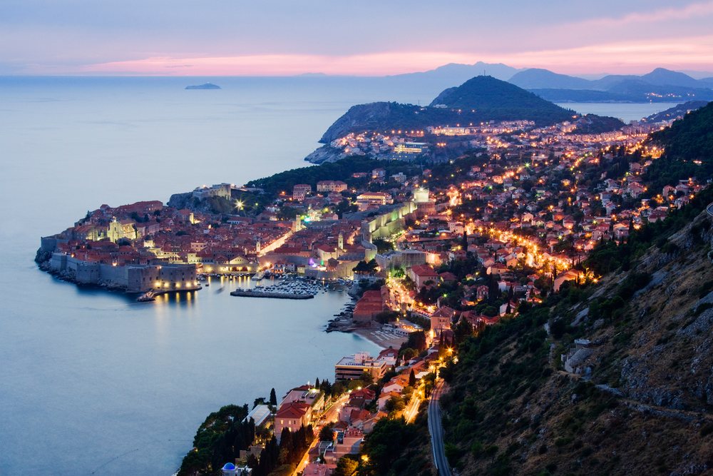 Old city of dubrovnik illuminated at dusk on croatian coastline