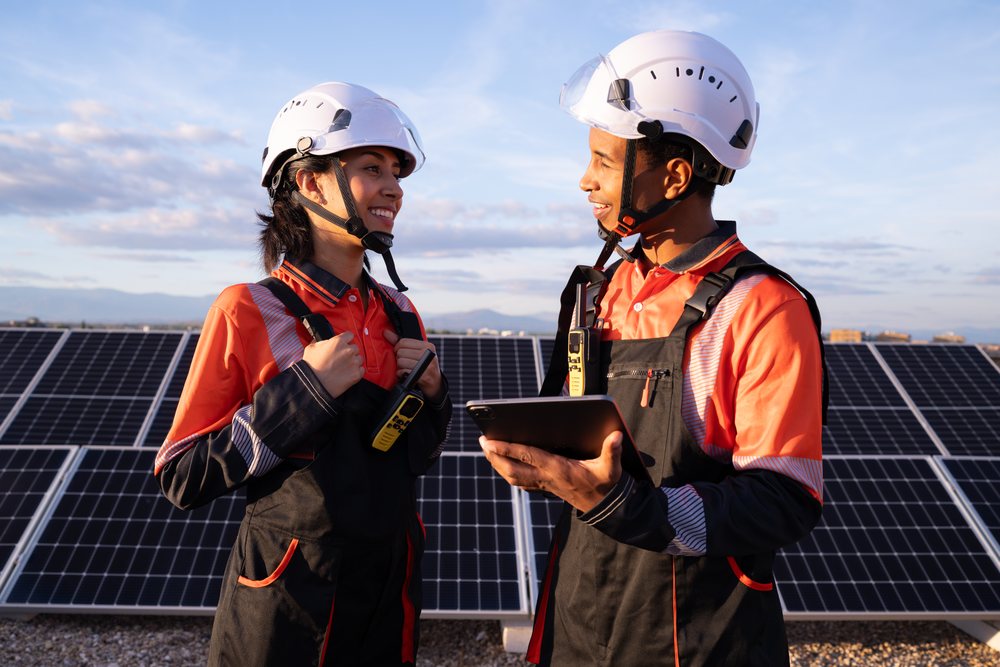 Engineers discussing solar energy production at solar panel array