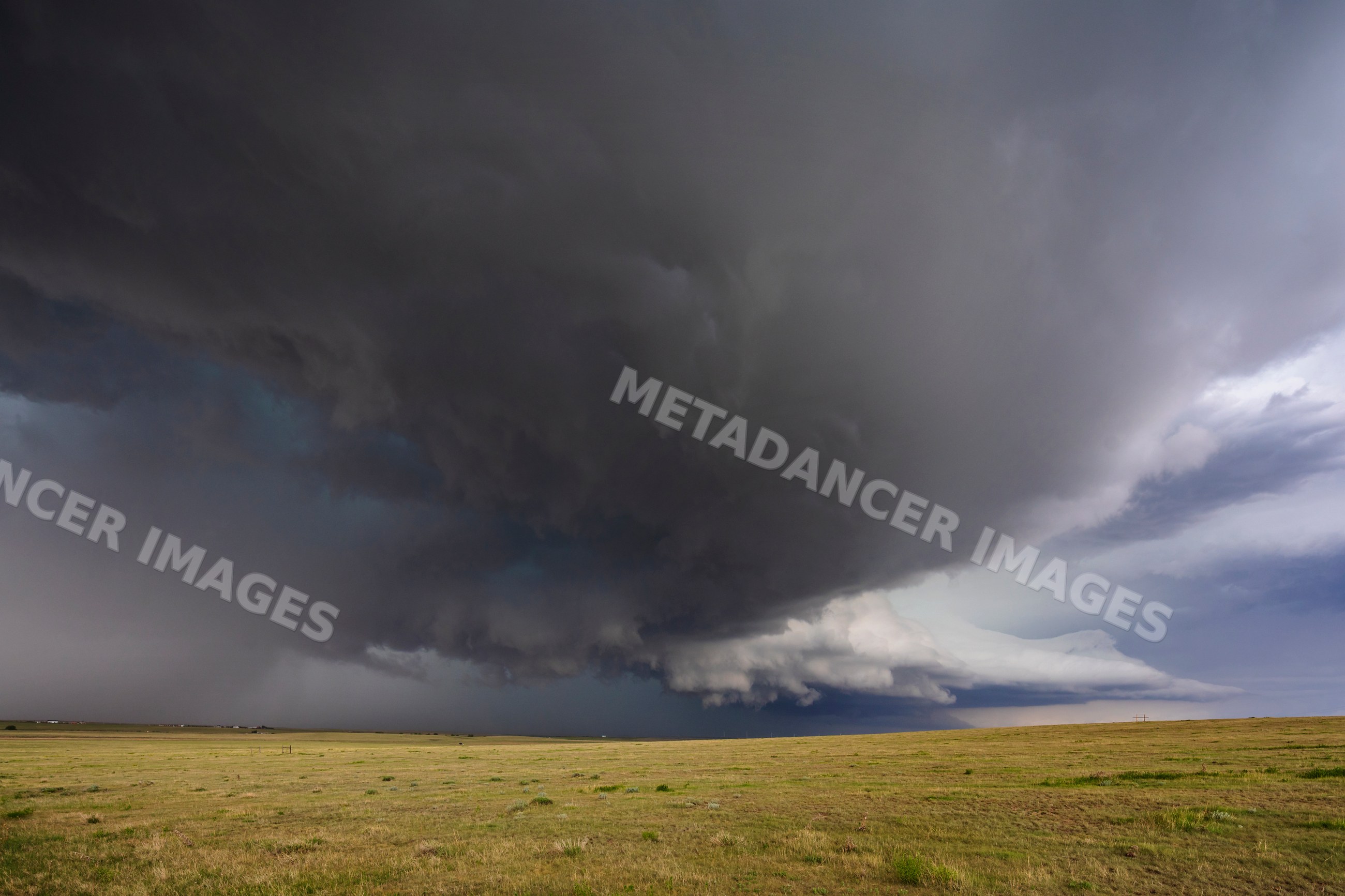 Supercell thunderstorm cloud forming over open plains near genoa