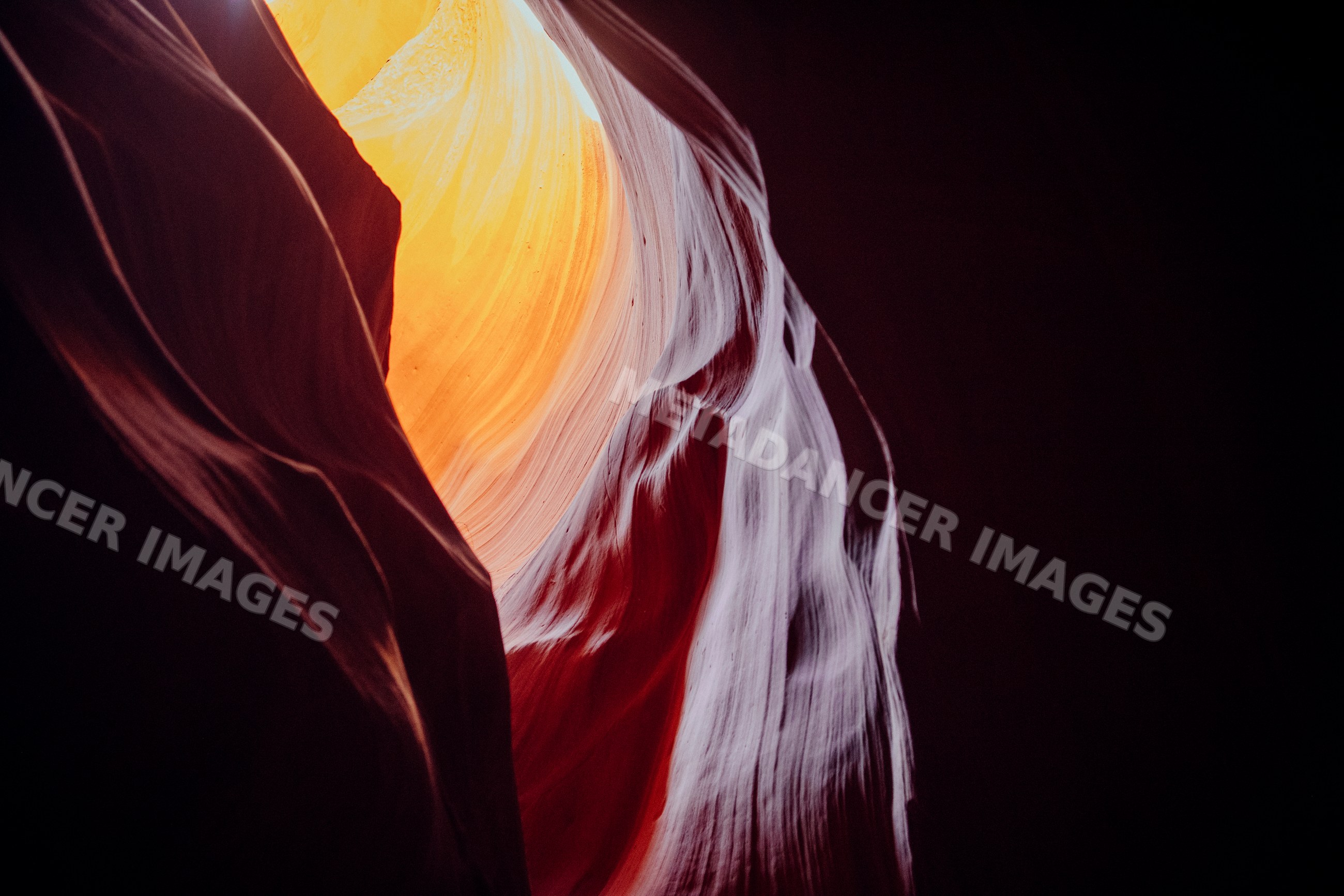 Illuminated sandstone rock walls inside antelope canyon slot canyon