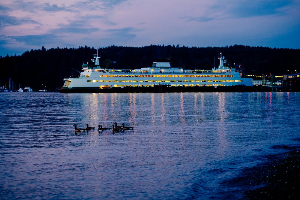 Ferry illuminated at dusk on water near Bainbridge Island