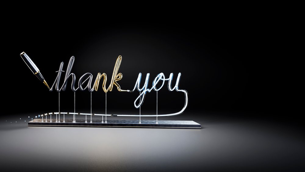 Metallic thank you script with pen on metal stand