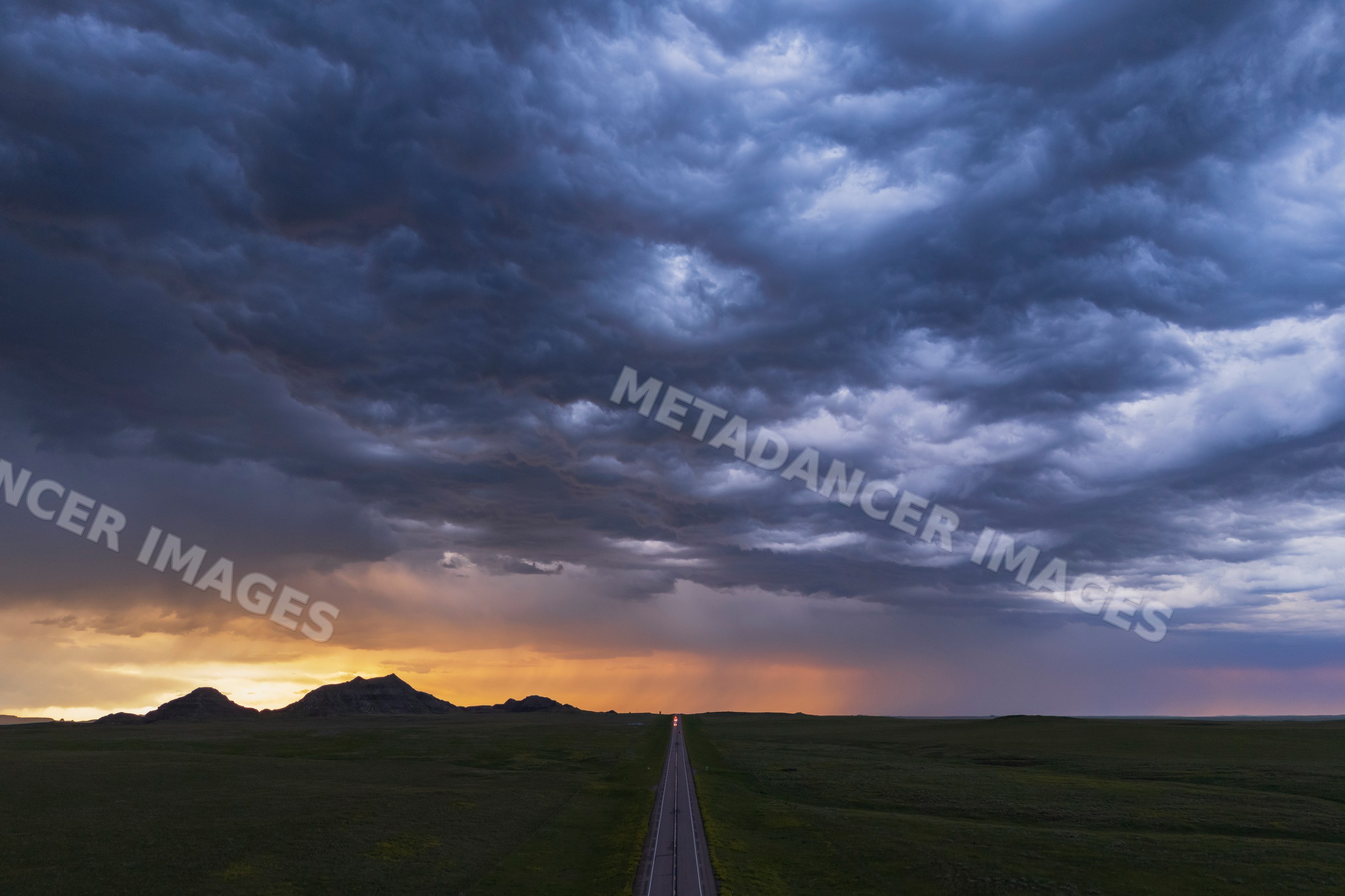 Sunset over Crow Buttes with storm clouds and highway