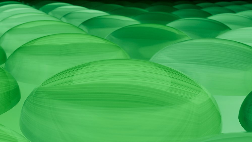 Smooth translucent green spheres in abstract digital illustration