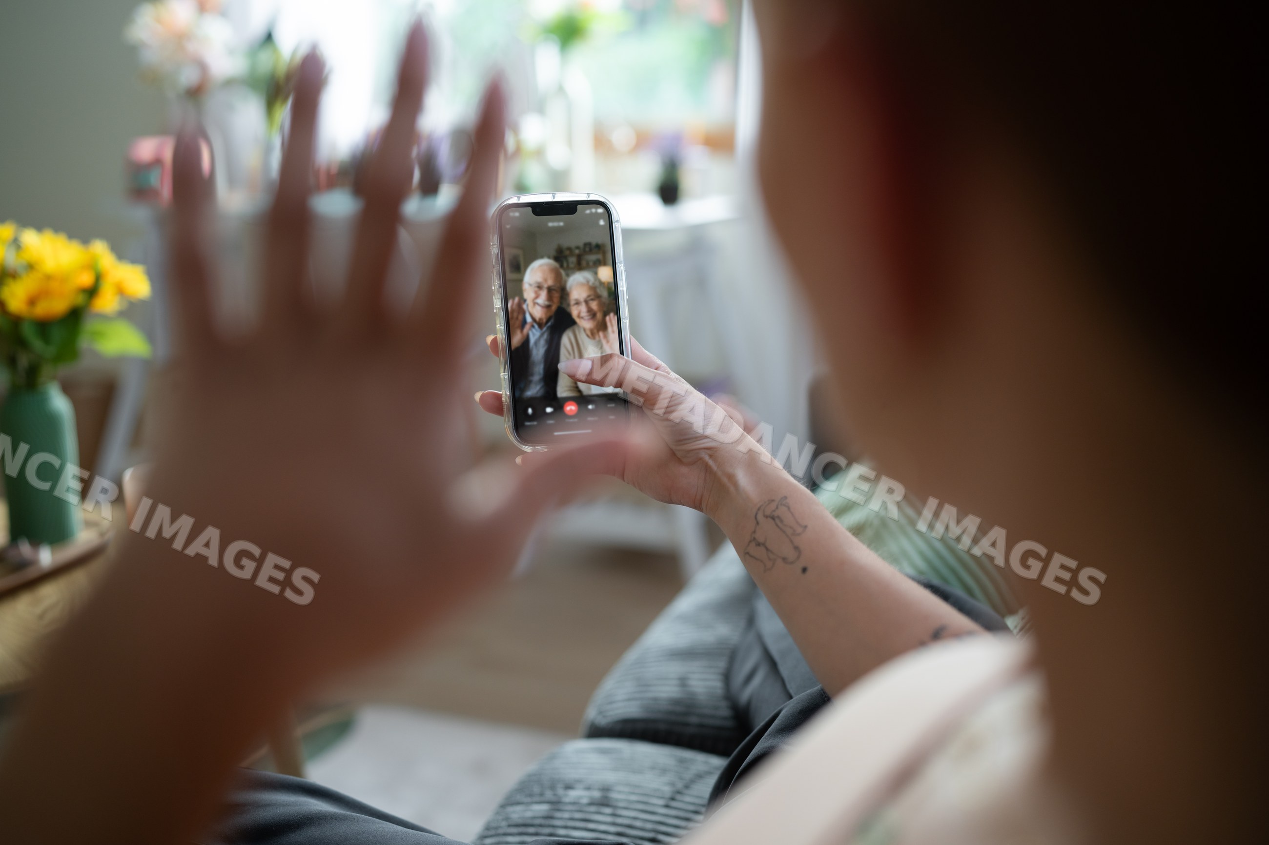 White Person video calling an older couple from home in Galicia