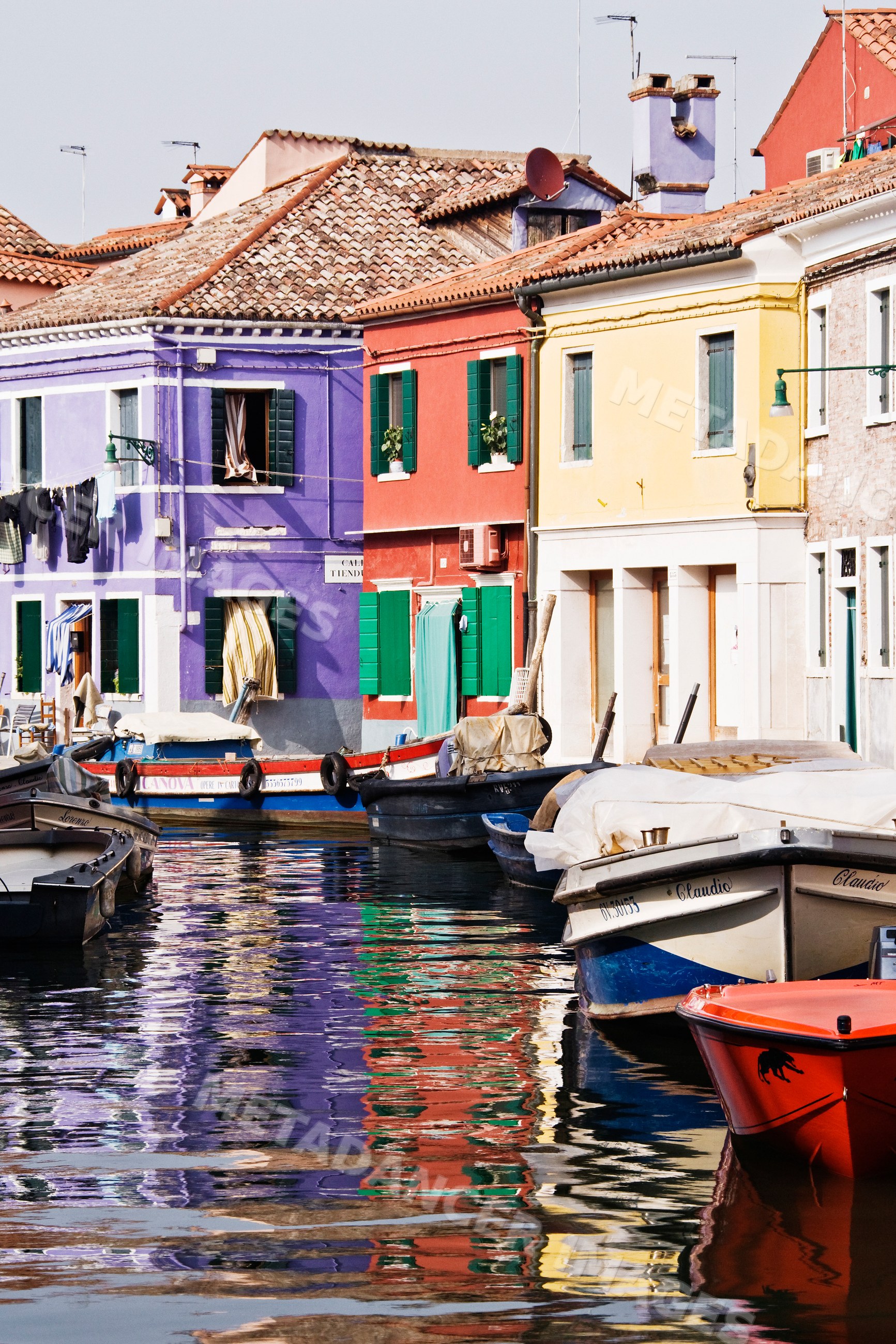 Colorful houses and boats along canal italy