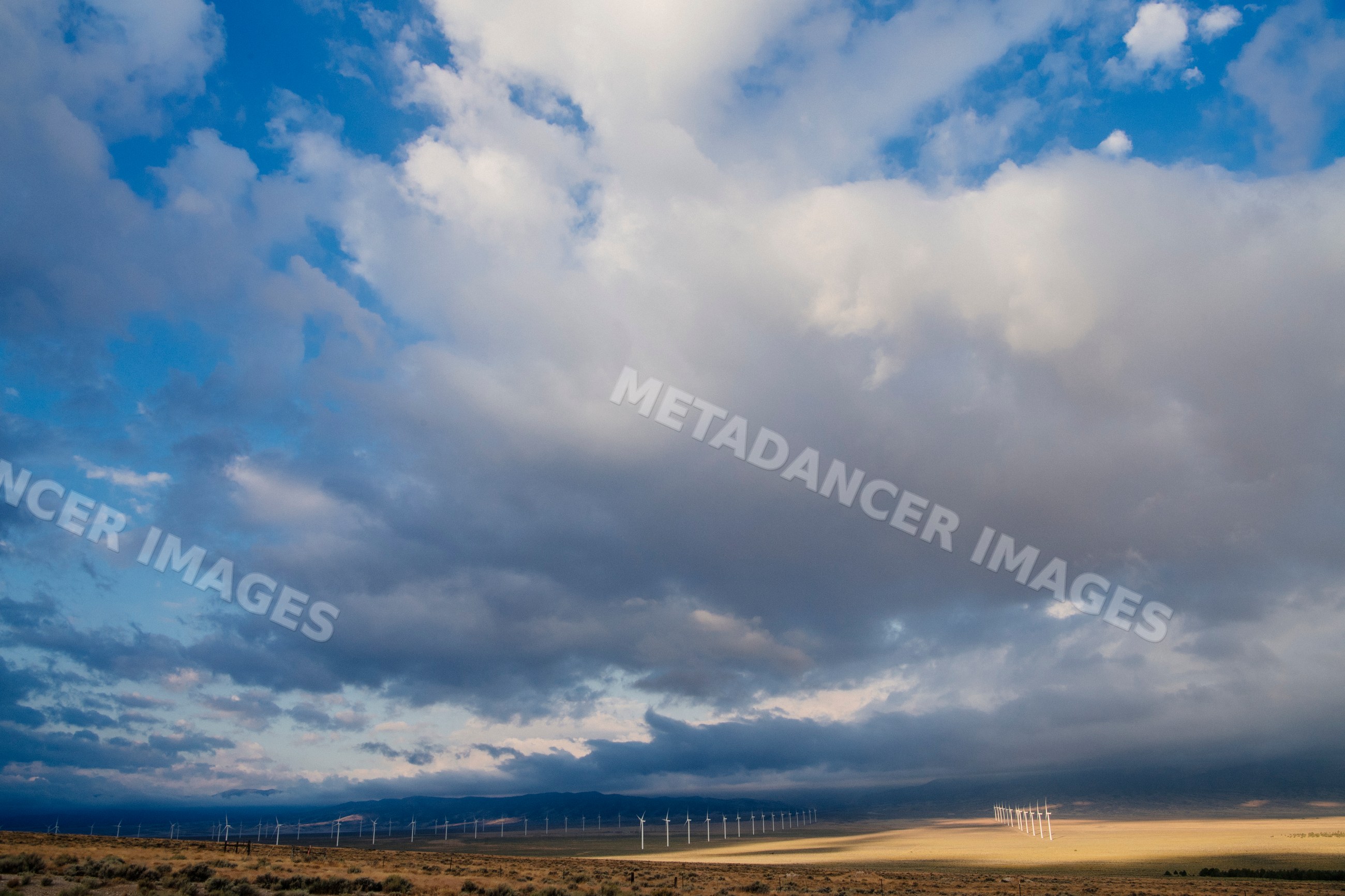 Wind turbines on a Nevada wind farm under cloudy sky
