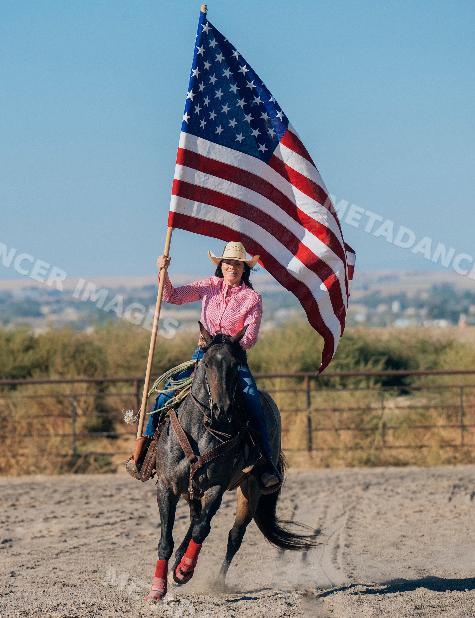 White woman horseback riding with american flag