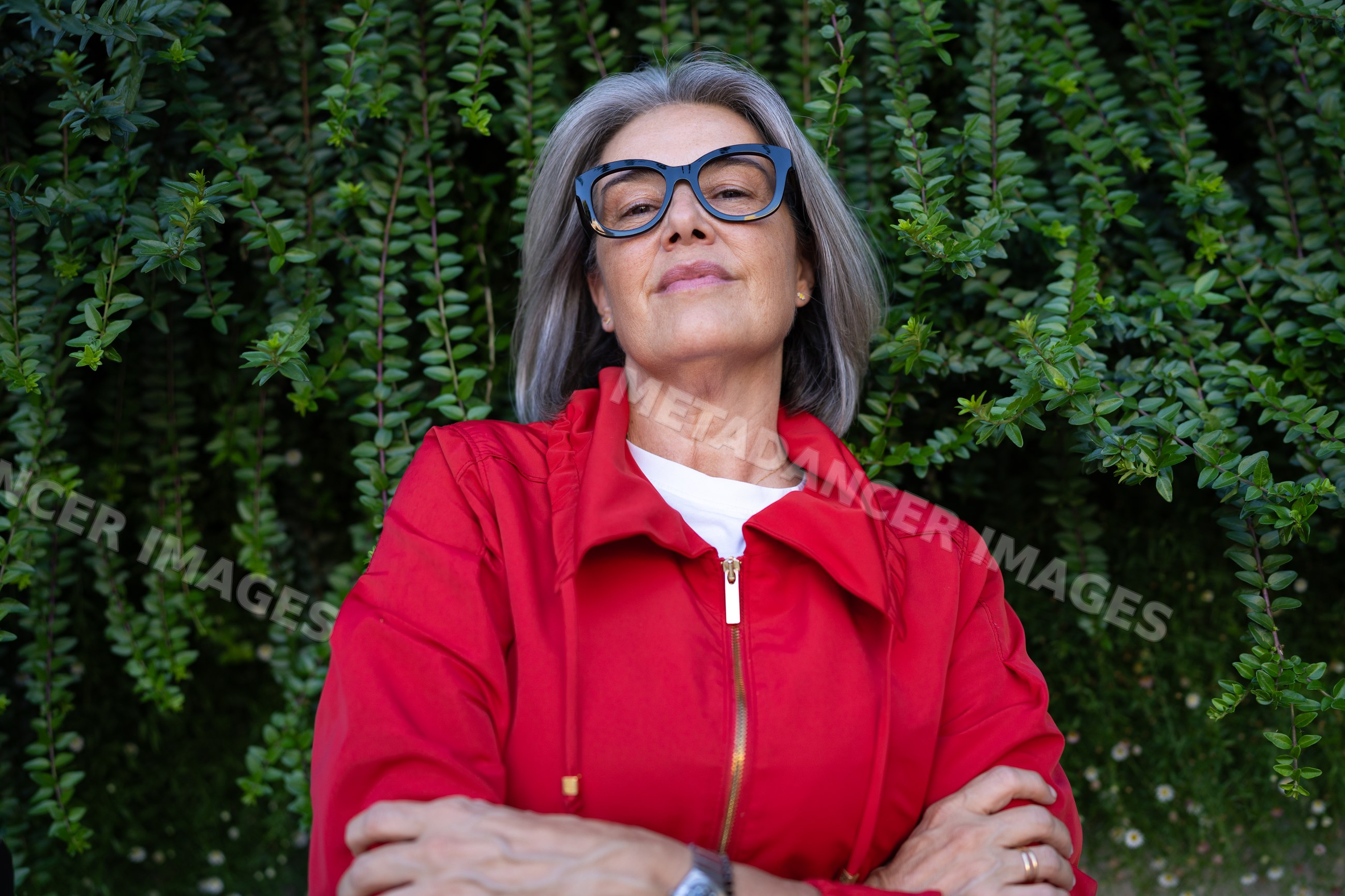 Confident middle-aged white woman wearing glasses and red jacket