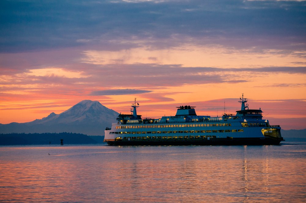 Ferry sailing at sunset with mount rainier in background