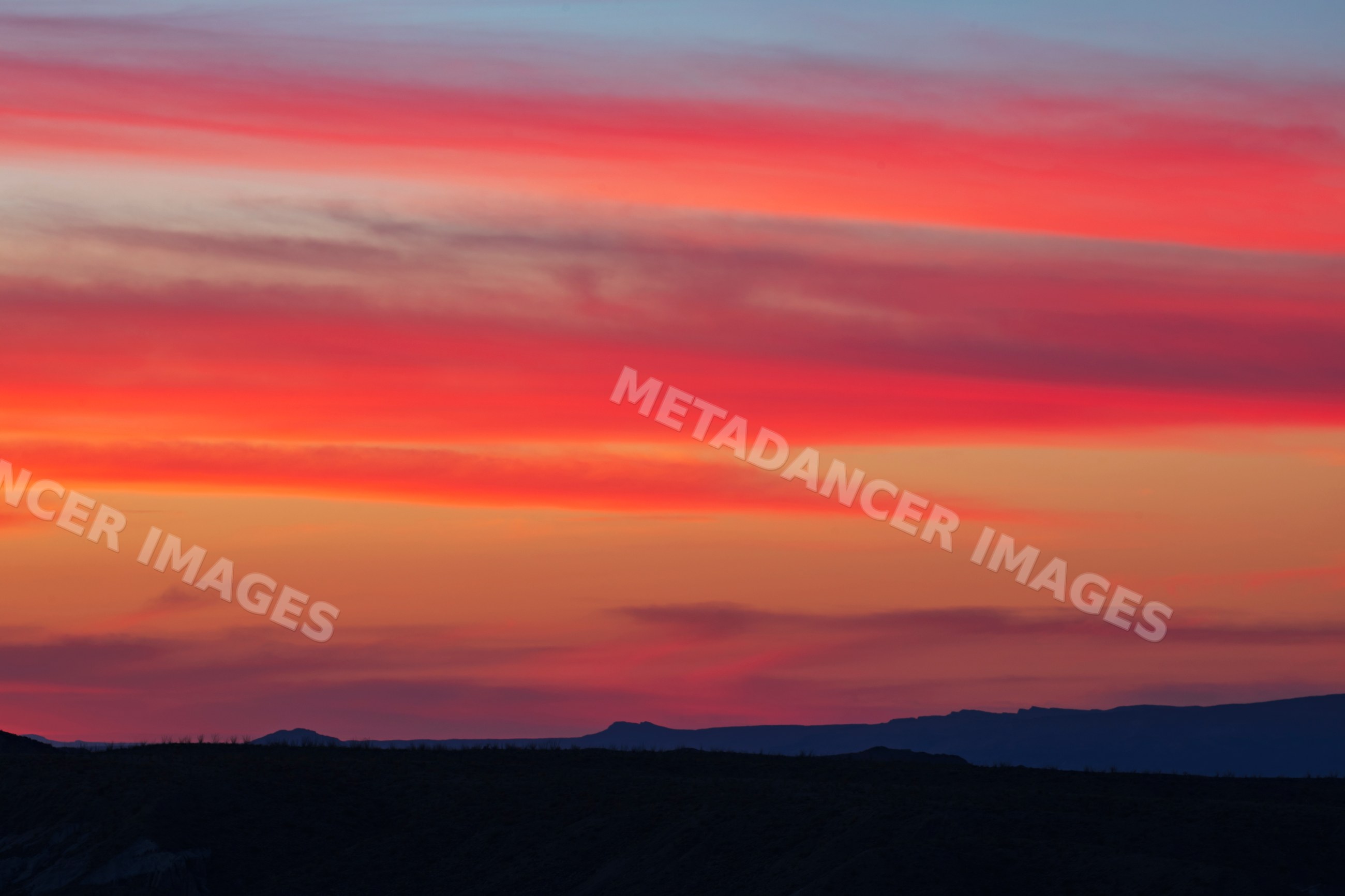 Big Bend Sunrise with colorful clouds over mountainous desert