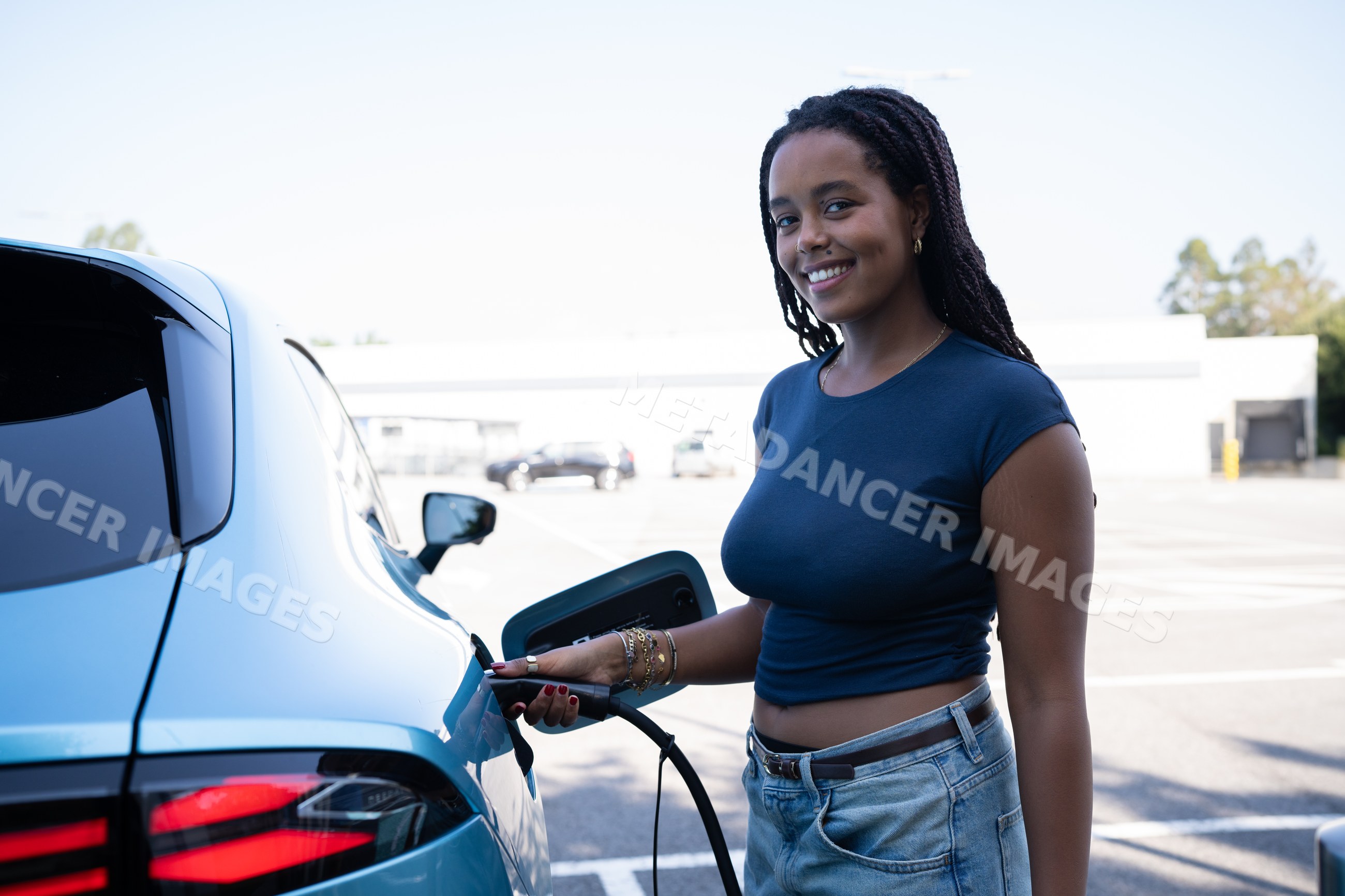African American Woman charging her electric vehicle