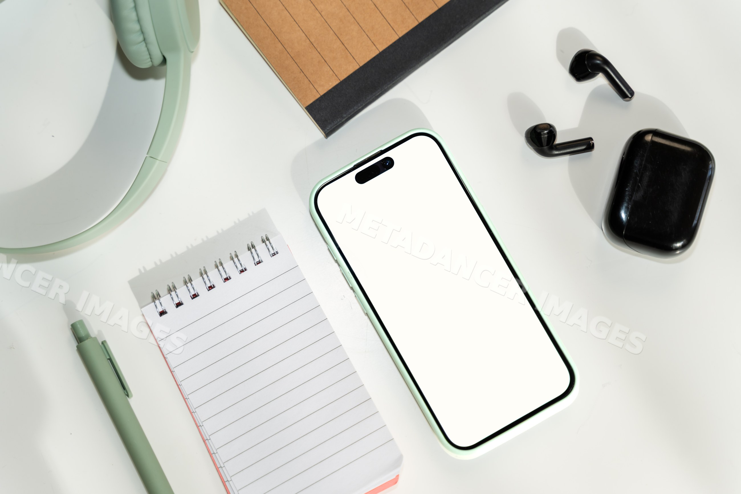 Smartphone and wireless earphones with notepad, pen