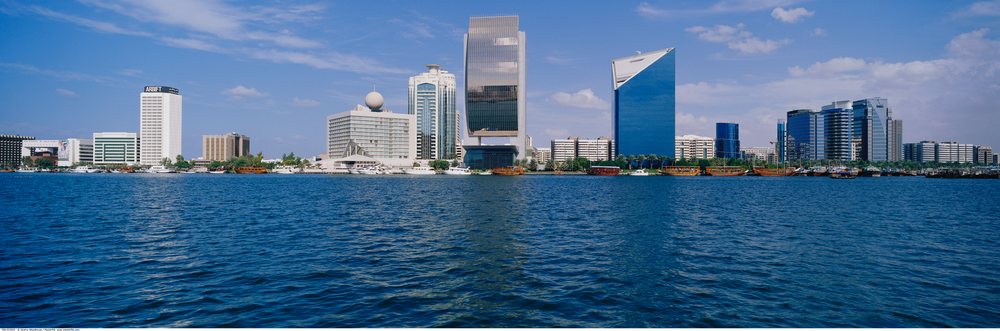 Dubai creek skyline with modern buildings and boats on waterfront
