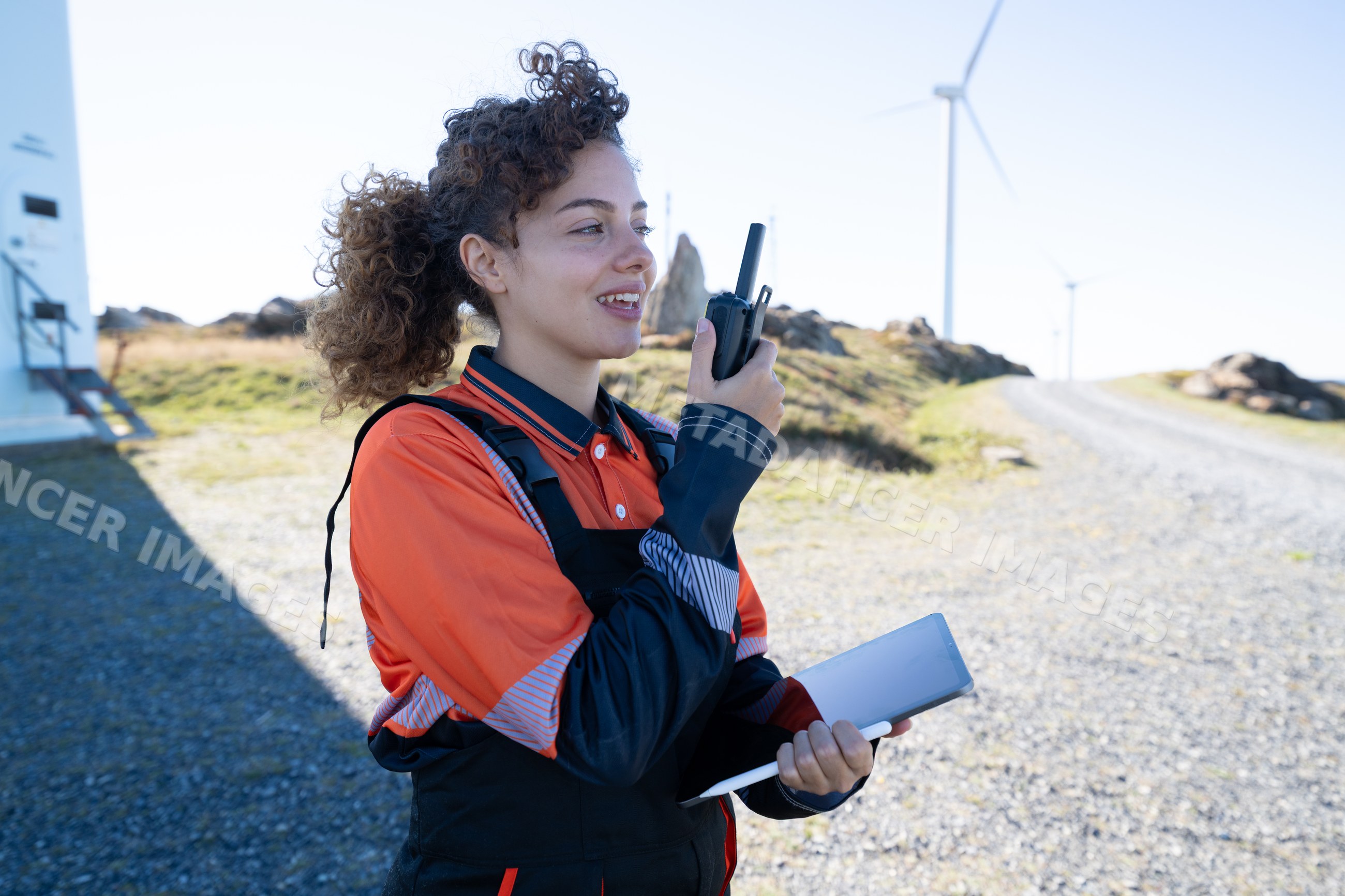 White woman using tablet and walkie-talkie