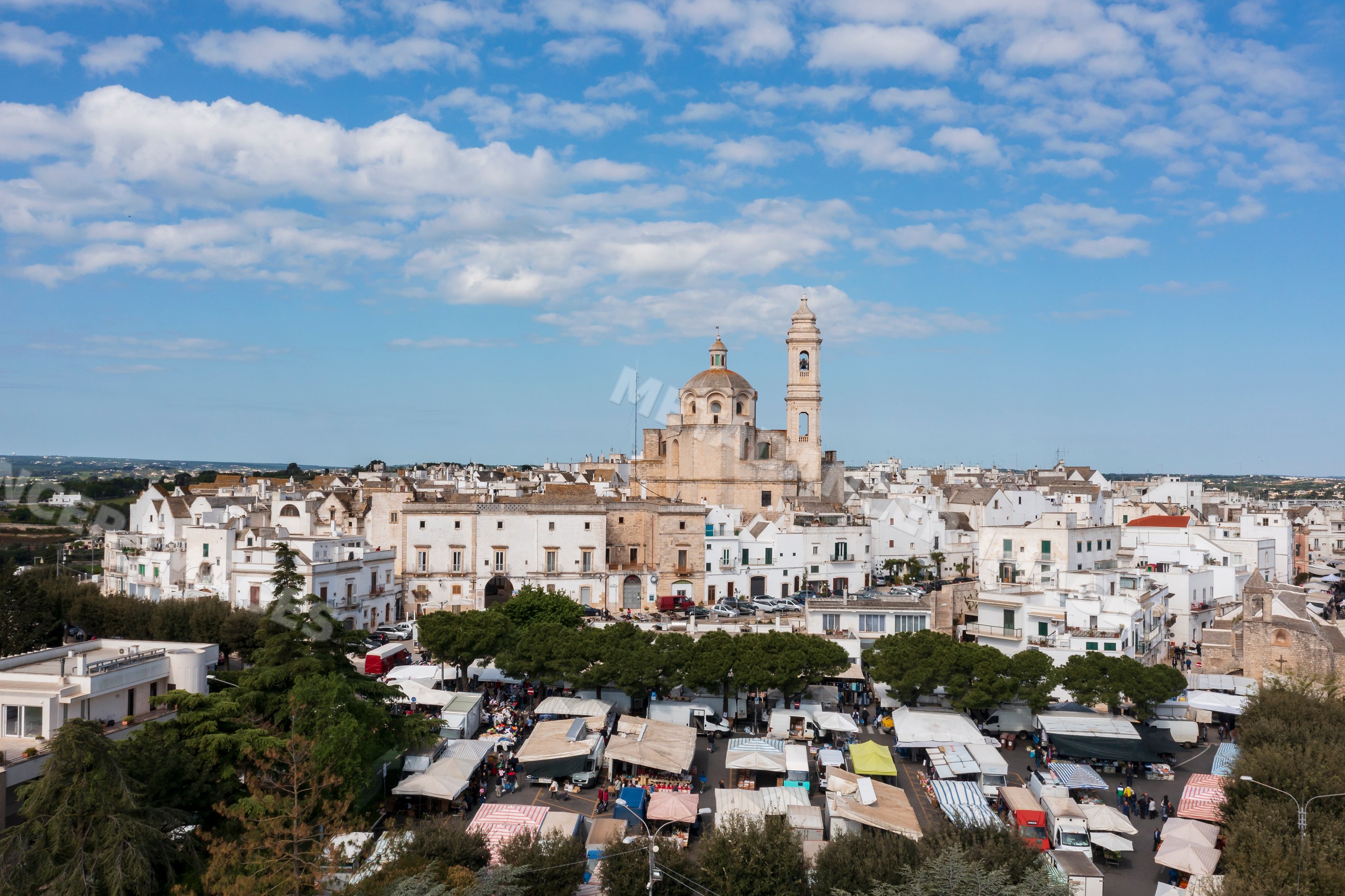 Market stalls and historic townscape in Locorotondo, Puglia, Italy