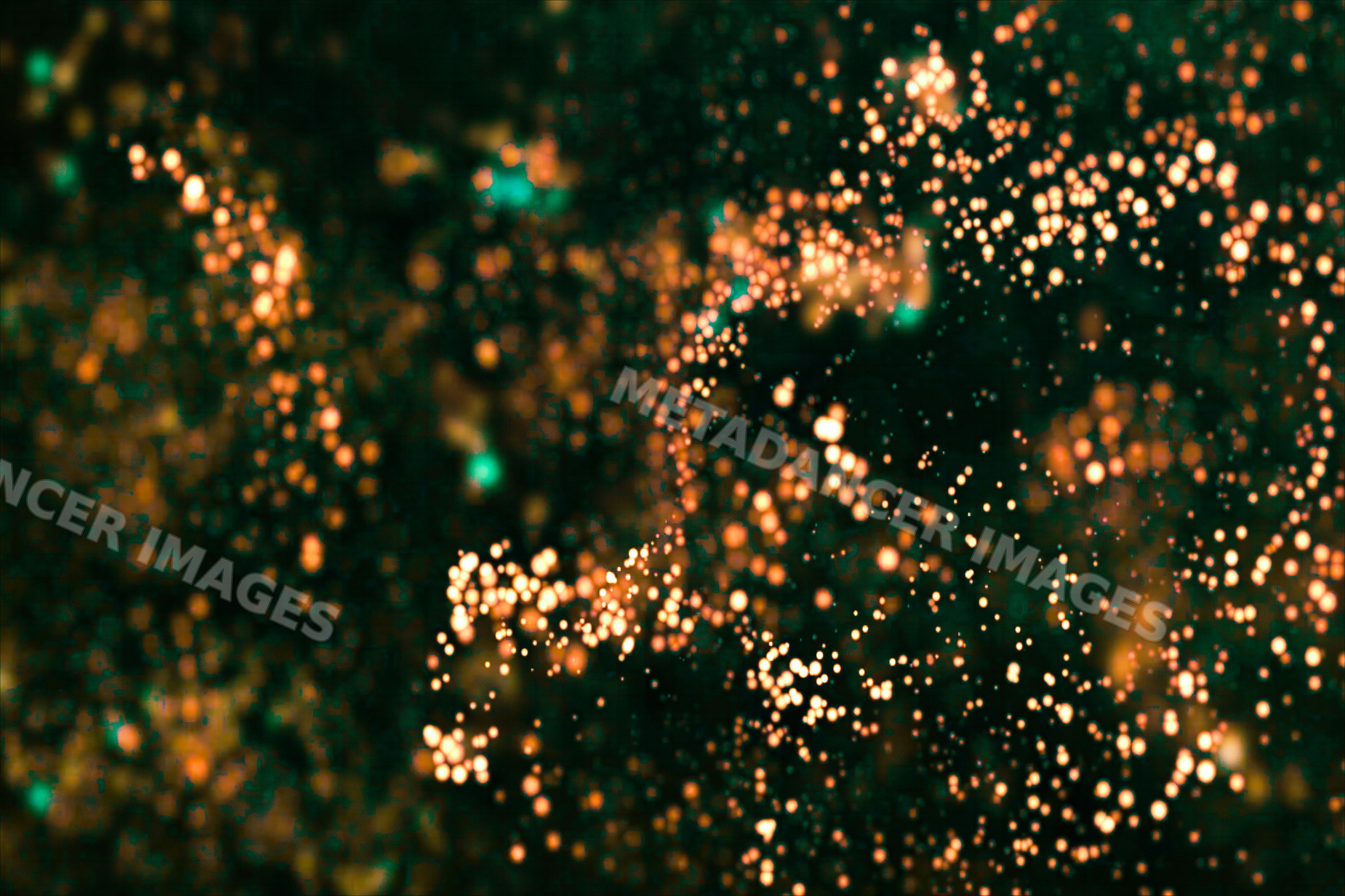 Close-up of glowing orange light particles on dark background