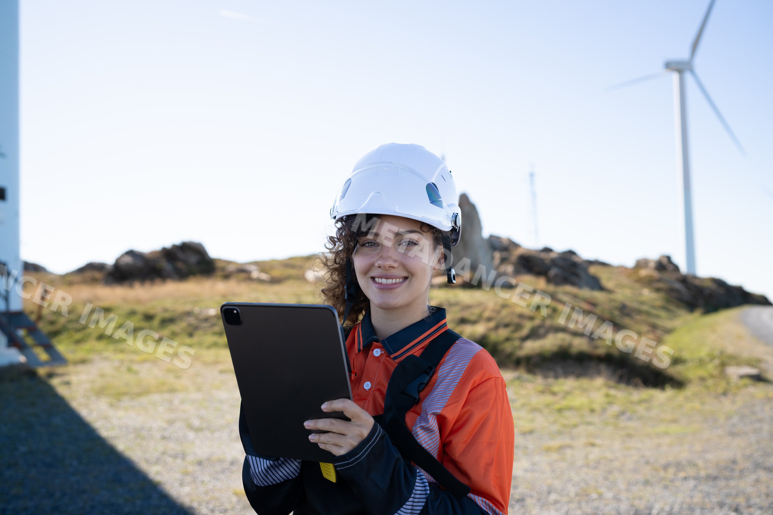 Female engineer holding tablet at wind farm in Galicia Spain